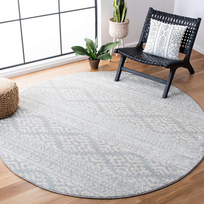 Round Safavieh Tulum Collection area rug in light grey and ivory with Moroccan boho pattern, perfect for modern living spaces.
