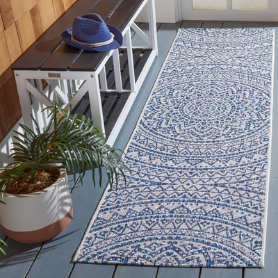 Safavieh Courtyard Collection 2x6.7 ivory and navy indoor/outdoor rug with geometric pattern and durable design.