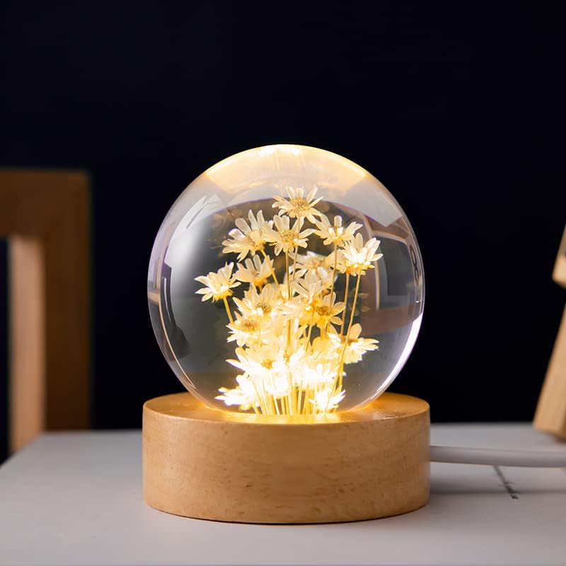 Red daisy flower crystal ball night light by MARZIUS, 2.4-inch glass lamp with wooden base, glowing with warm light.