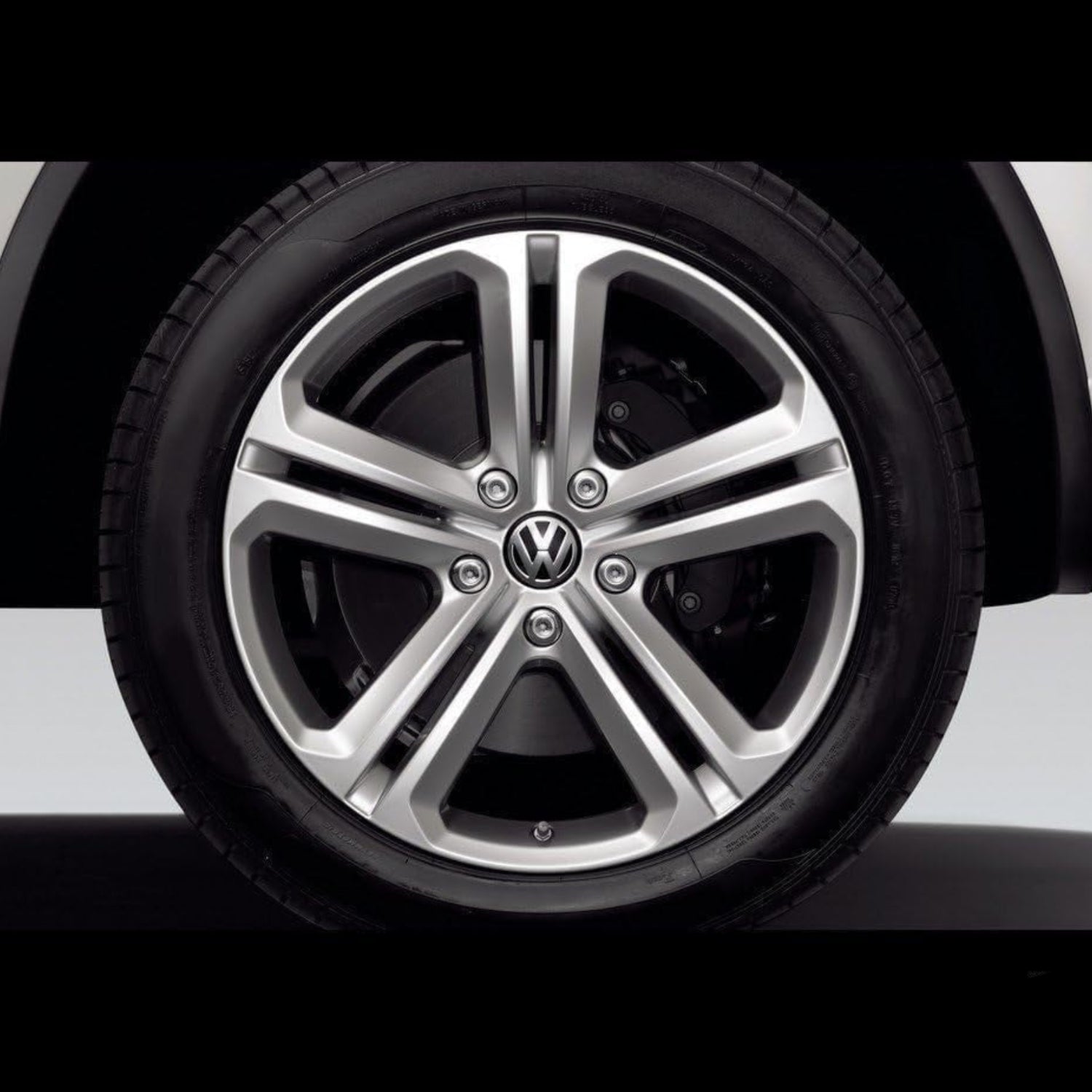 Volkswagen center cap with VW logo, unbranded wheel accessory for vehicle hub covering, shown on a car wheel.