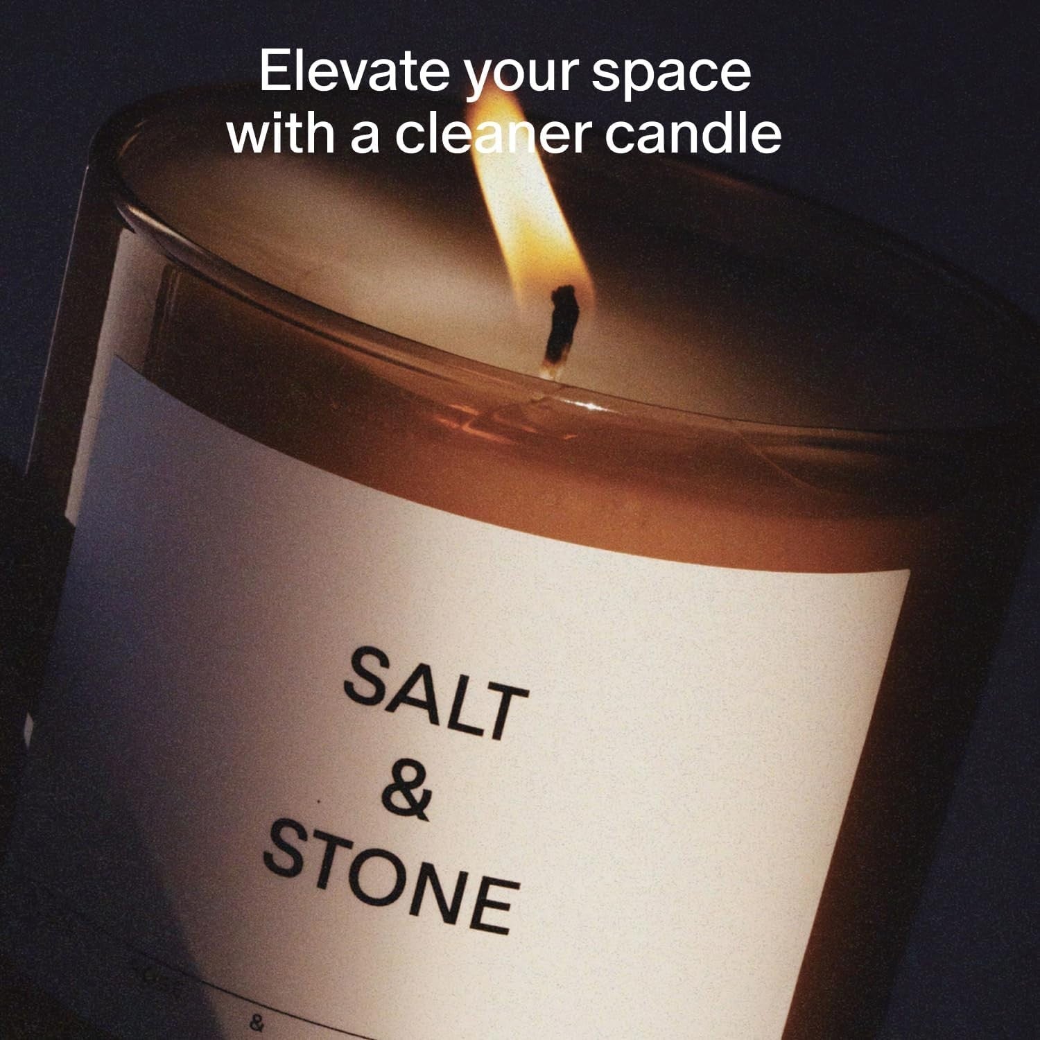 Salt & Stone Black Rose & Oud scented candle in an 8.5 oz soy and coconut wax, featuring a sleek black design and 50-hour burn time.