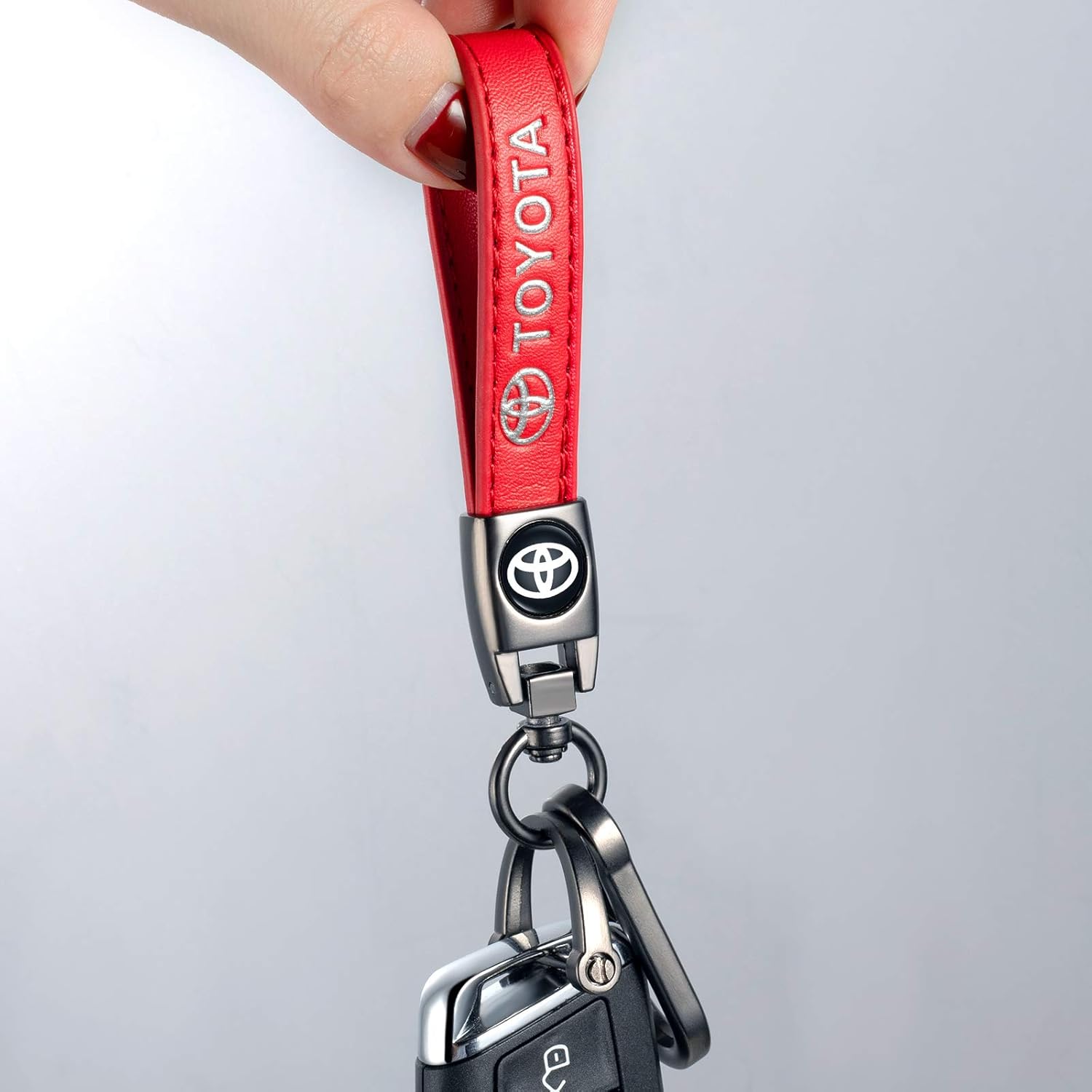 Black TACOMA genuine leather car keychain with metal key ring, stylish accessory for men and women.