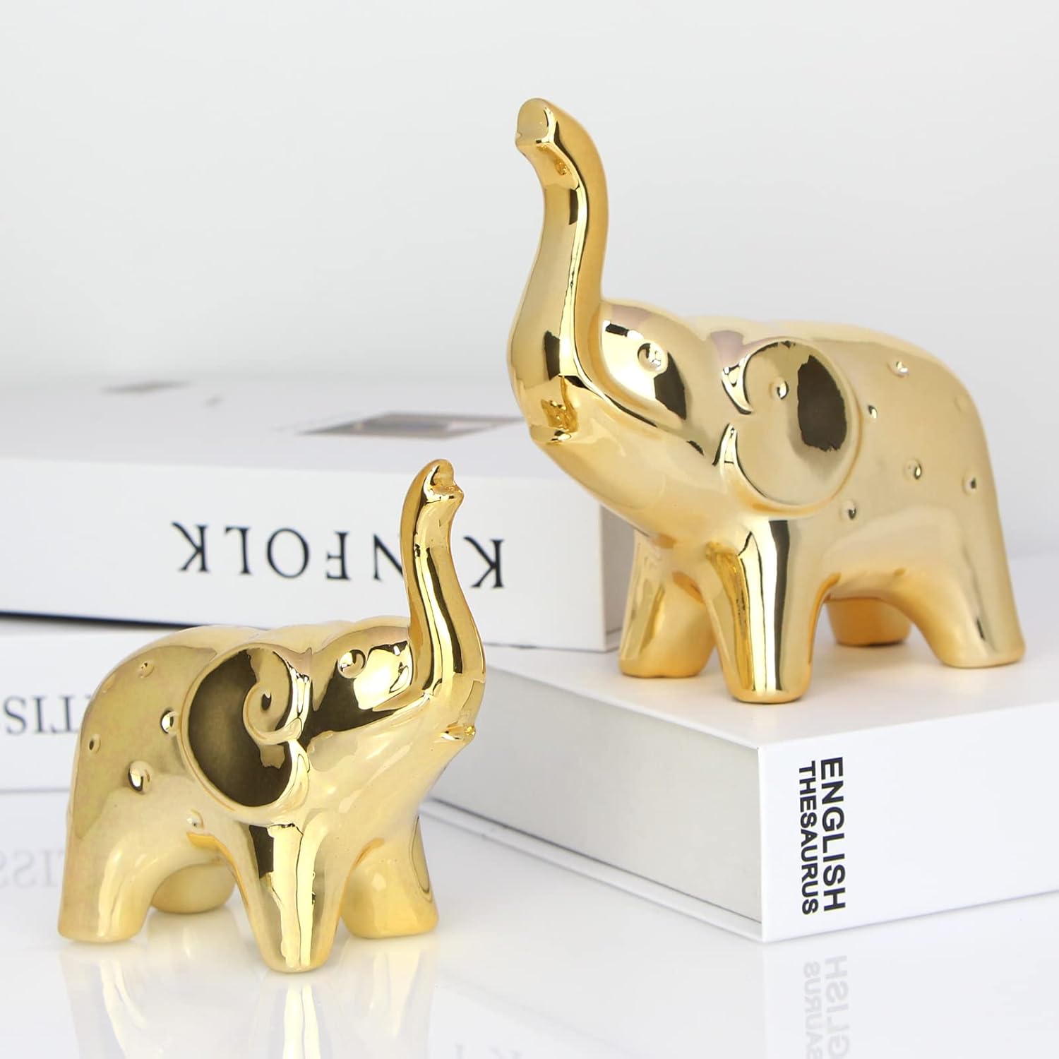 Modern Sgorggo Prosfalt elephant statue pair for home decor, featuring detailed elephant figurines and sculptures in a contemporary style.