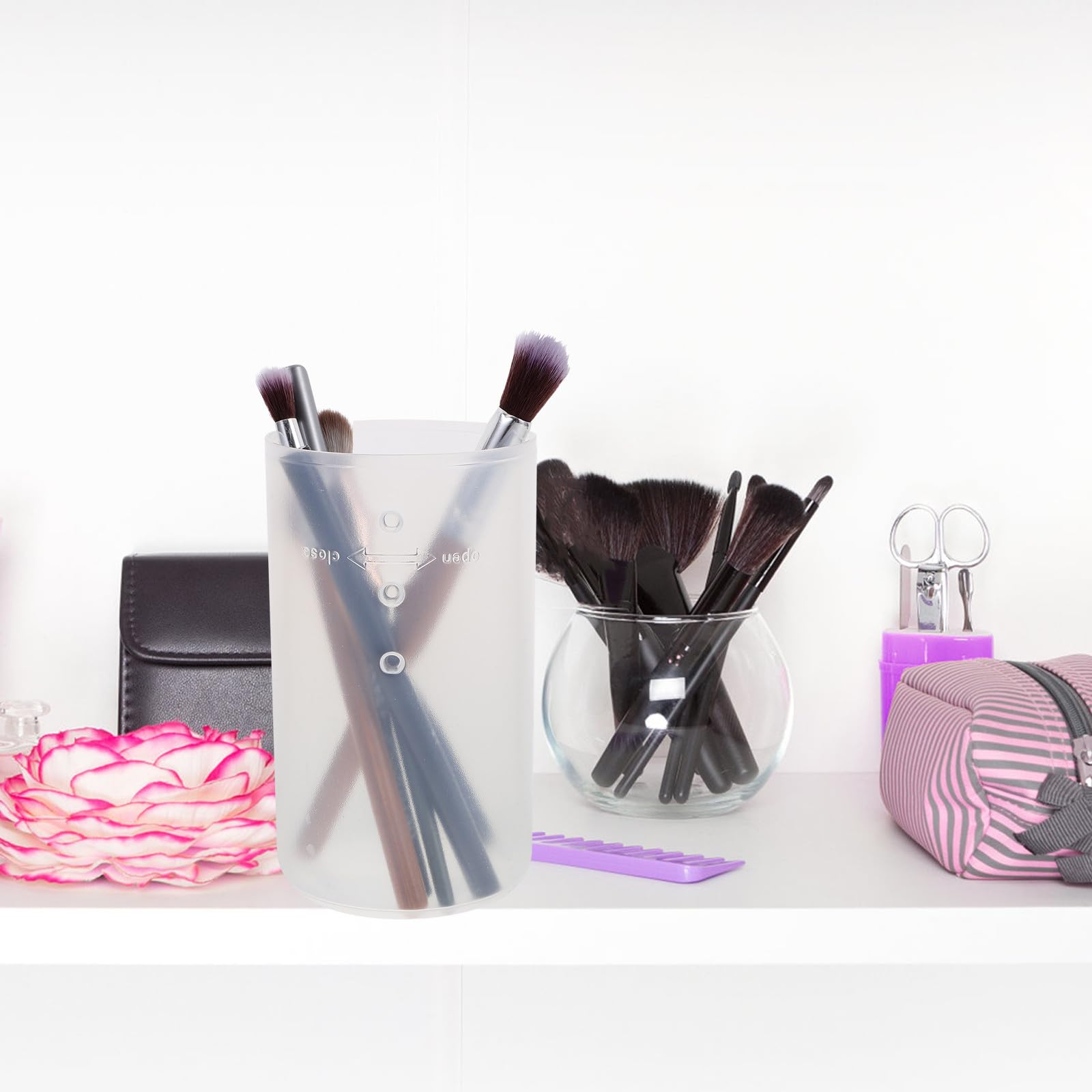 FOYTOKI makeup brush holder caddy with lid, three retractable plastic cups for organizing brushes and makeup tools on vanity.