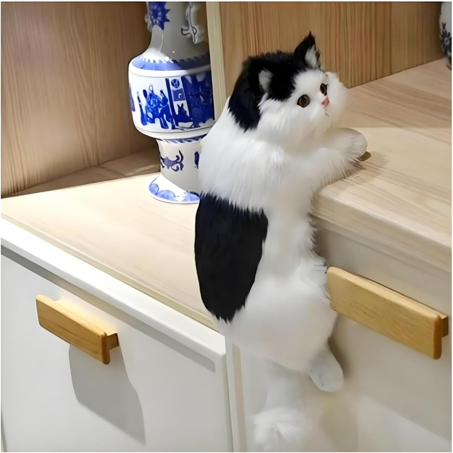 Realistic black and white furry kitty hanging cat figurine, adorable simulation cat gift for decoration or collection.