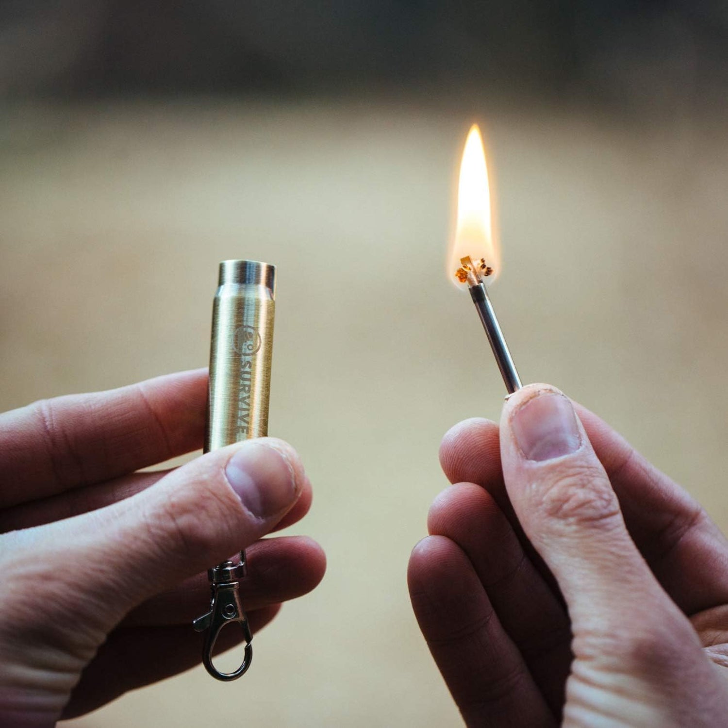 SURVIVE permanent match bullet keychain with metal quick clip, reusable survival fire-starting tool, compact and durable.
