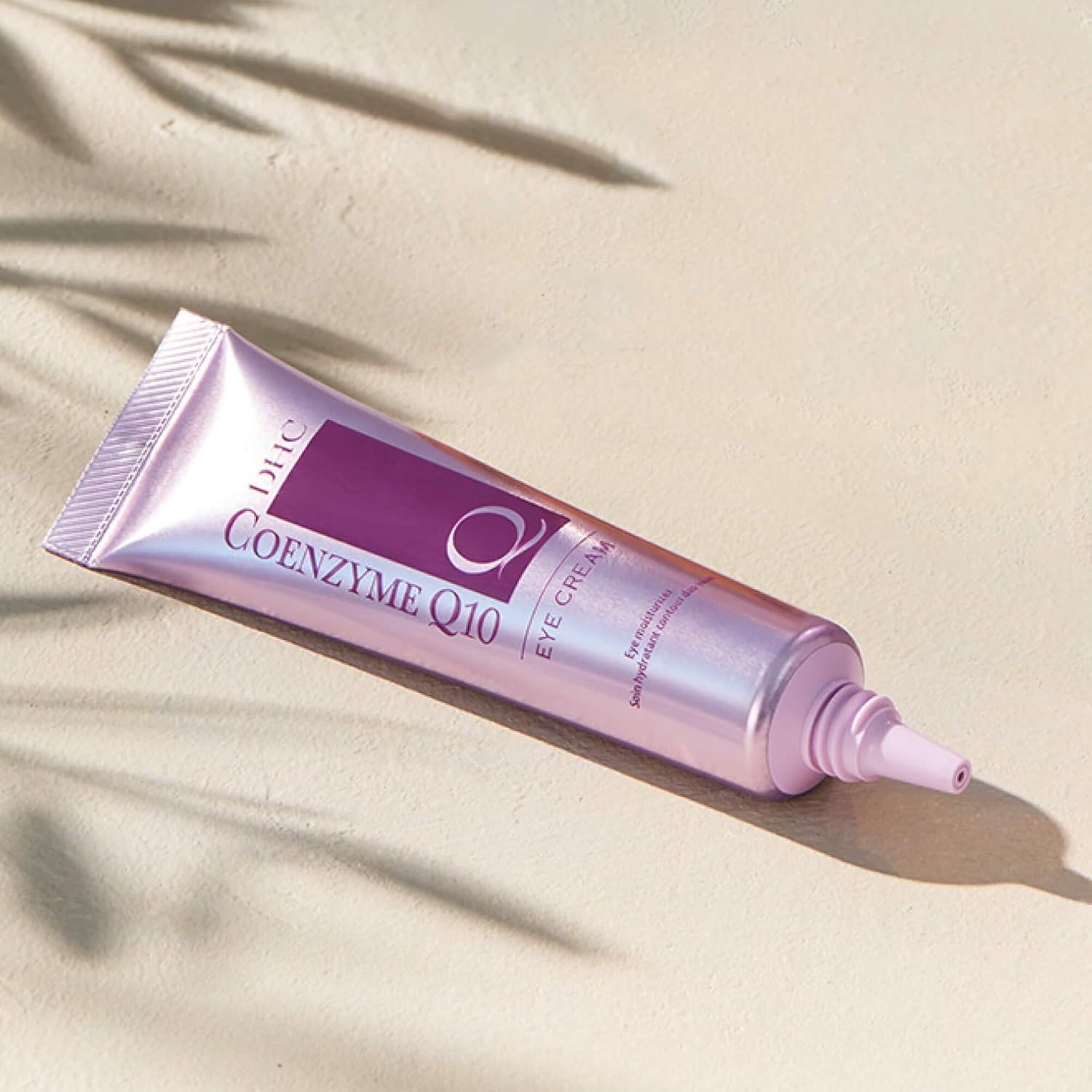 DHC CoQ10 eye cream jar with applicator, antioxidant treatment for fine lines and crow's feet under the eyes.