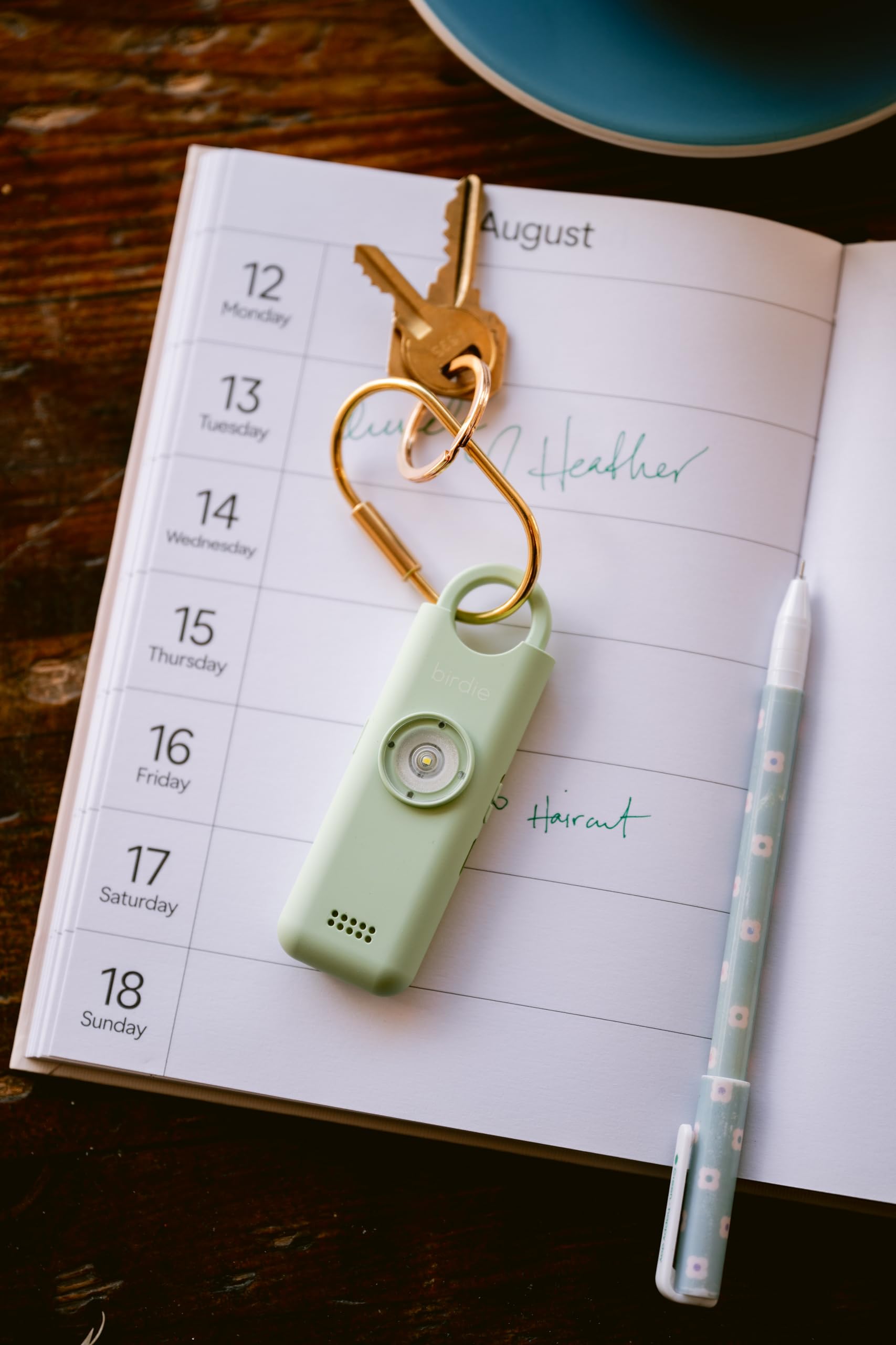 She's Birdie 3.0 personal safety alarm for women, featuring a loud siren, flashlight, and rechargeable battery in aqua blue color.