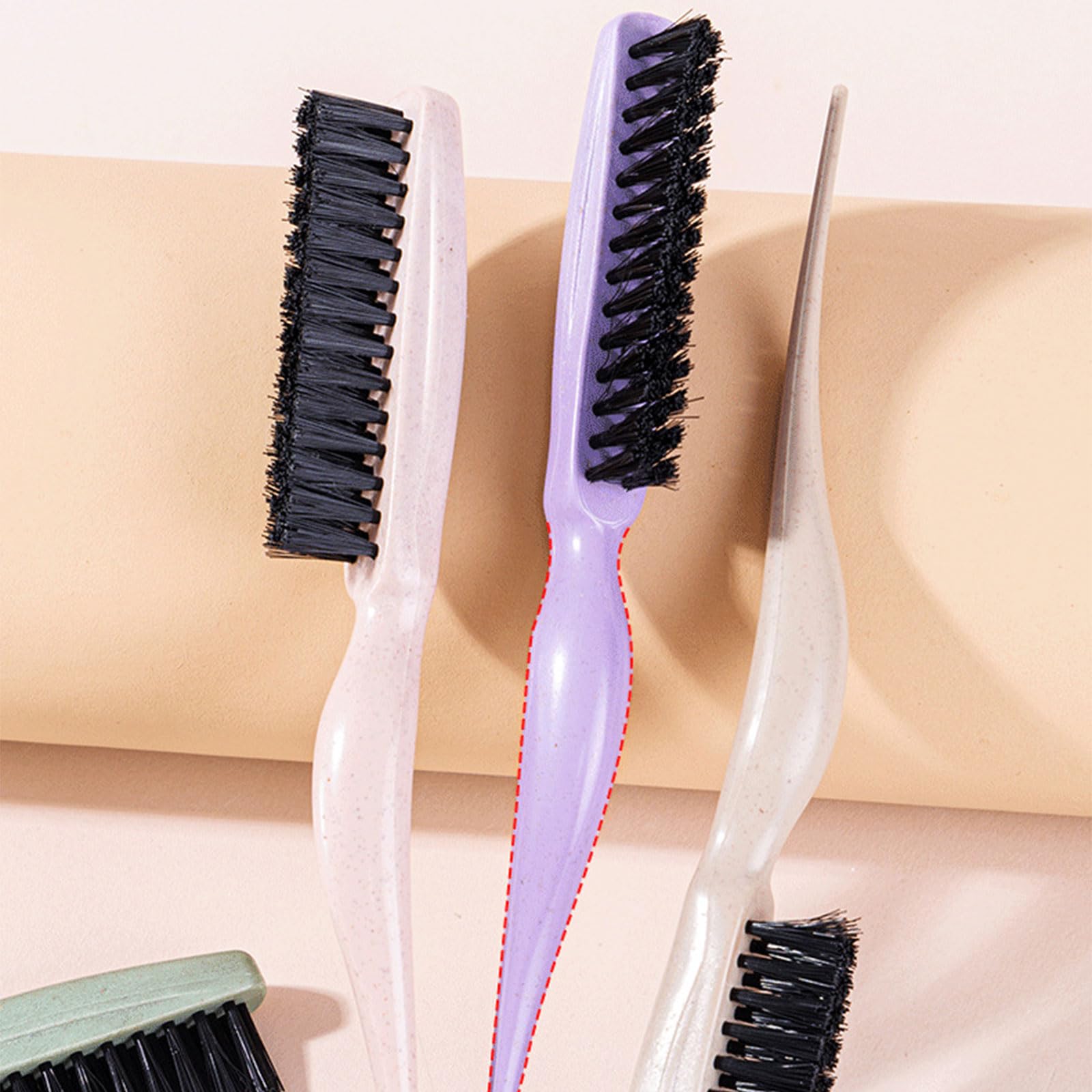 YUGSHNKFC teasing hair brush with green nylon bristles and a tail handle for styling and detangling hair.