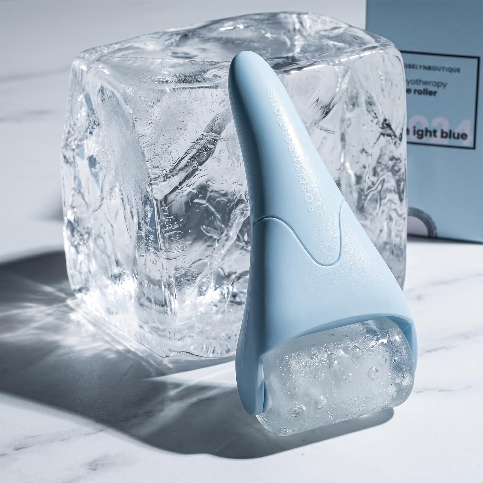 ROSELYNBOUTIQUE light blue ice roller and gua sha facial massager for skin cooling and contouring.