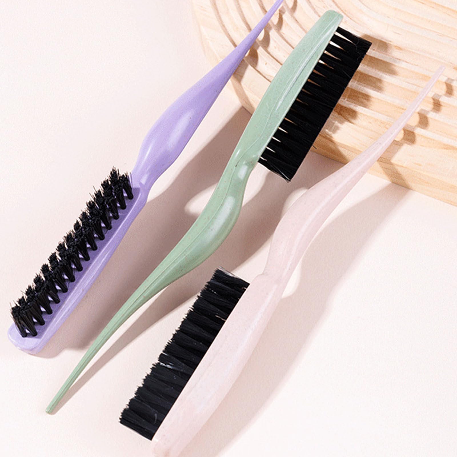 Green teasing hair brush with nylon bristles and a tail handle by YUGSHNKFC, ideal for styling and teasing hair.