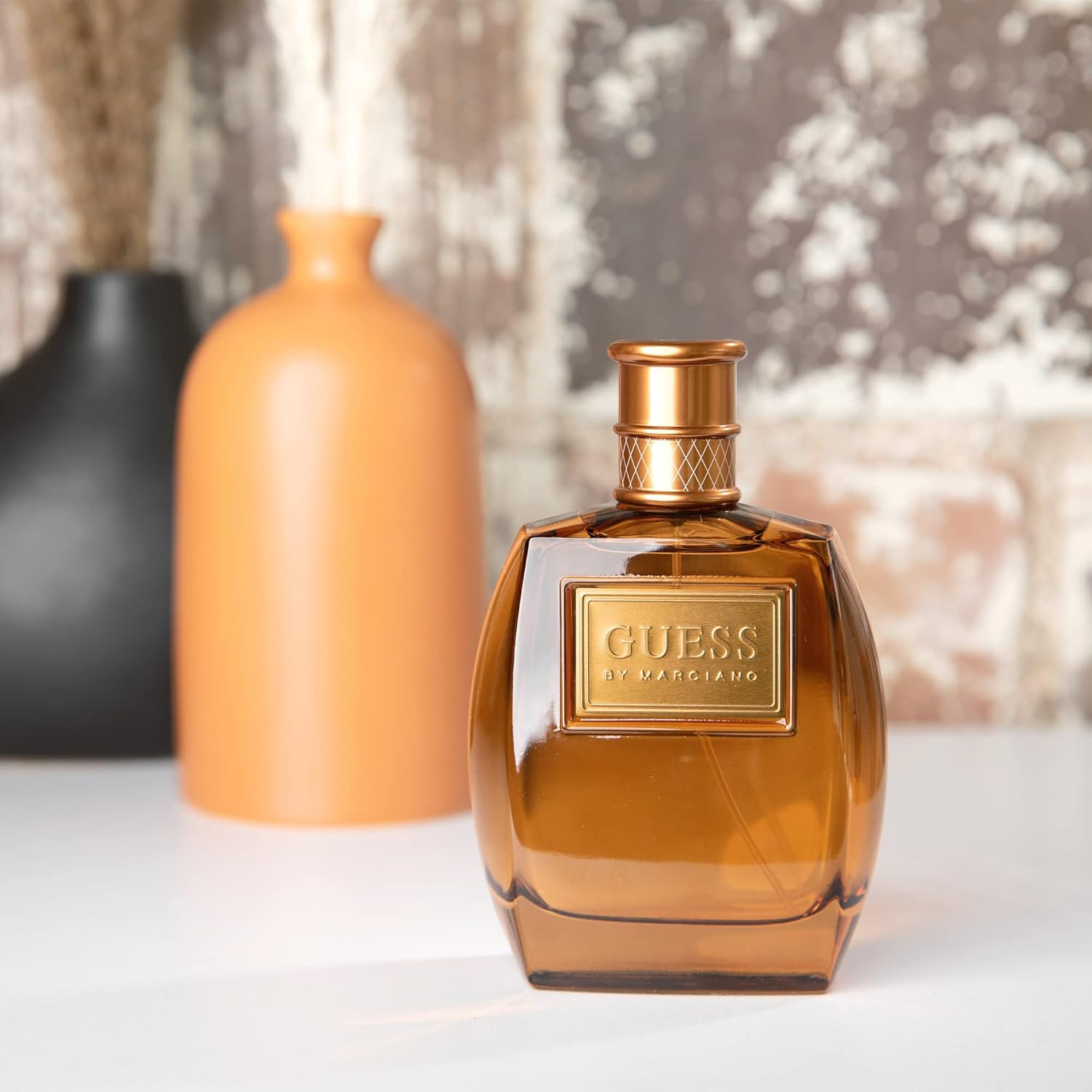 GUESS Marciano men's Eau de Toilette cologne spray bottle, 3.4 fl oz, featuring a sleek design and modern branding.