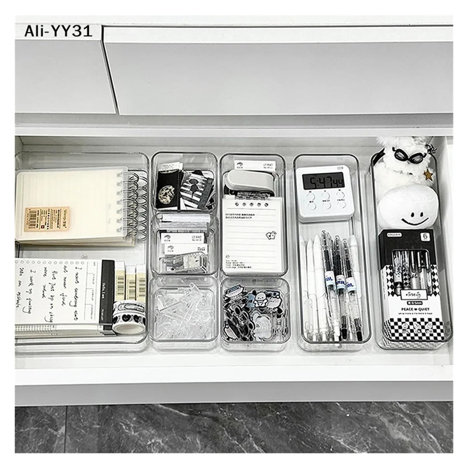 Clear stackable acrylic drawer organizer caddy with adjustable dividers for cosmetics and makeup storage.