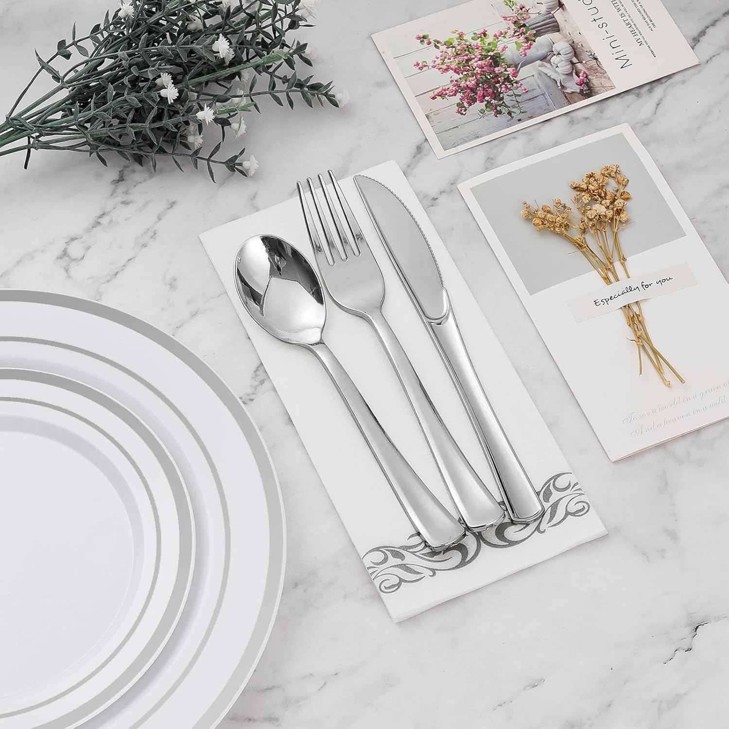 BESTVIP 700-piece silver plastic dinnerware set for 100 guests, including plates, bowls, and utensils, all neatly arranged.