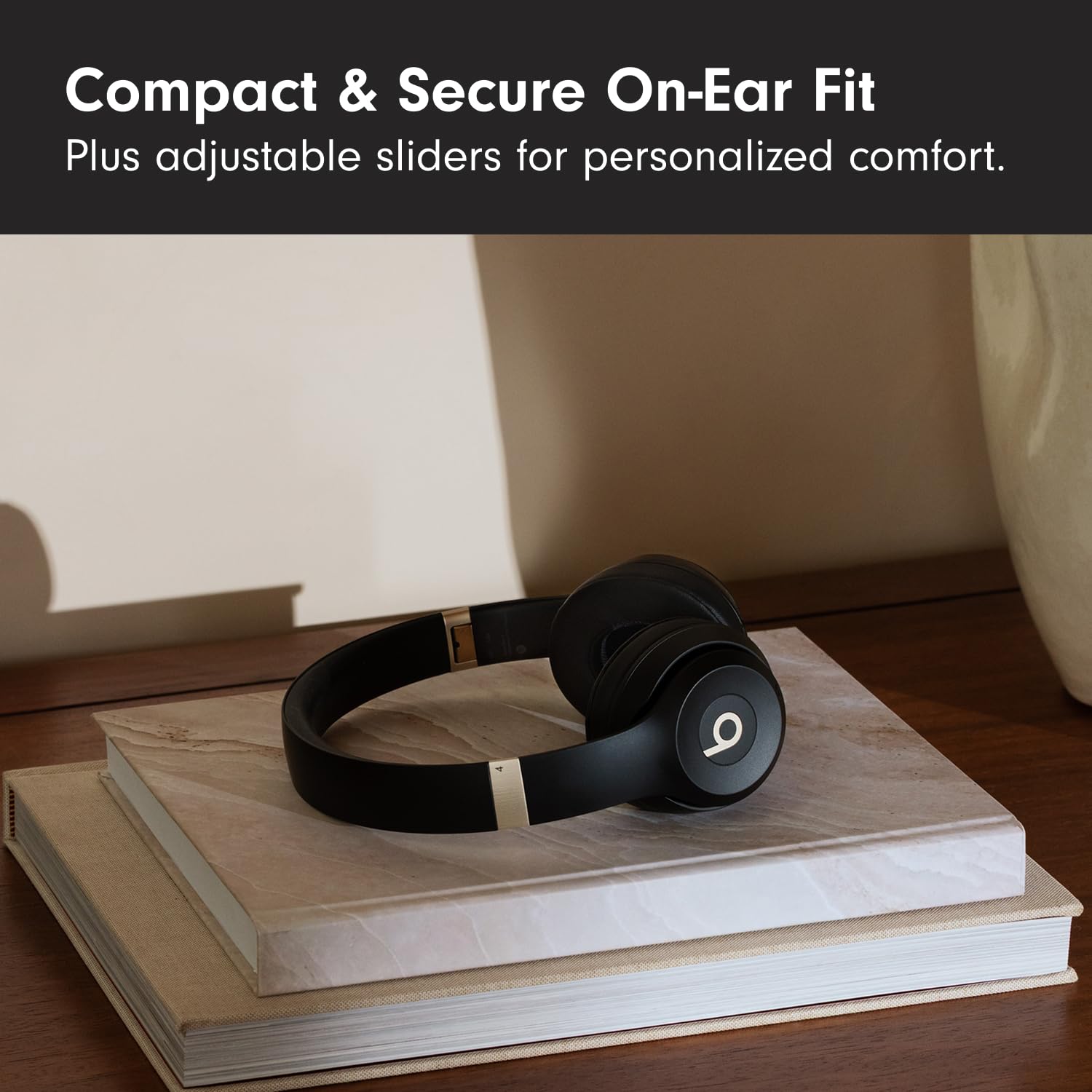 Beats Solo 4 wireless on-ear Bluetooth headphones in black and gold with sleek design, showing the headphones with ear cushions.