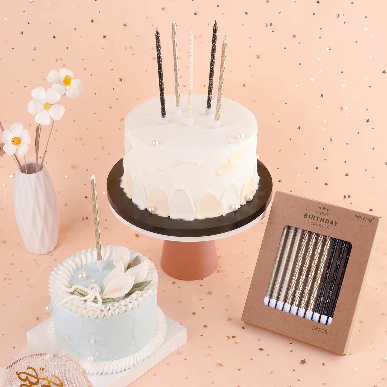 Set of three PHD CAKE gold, black, and white long thin birthday candles on a cake, ideal for celebration desserts.