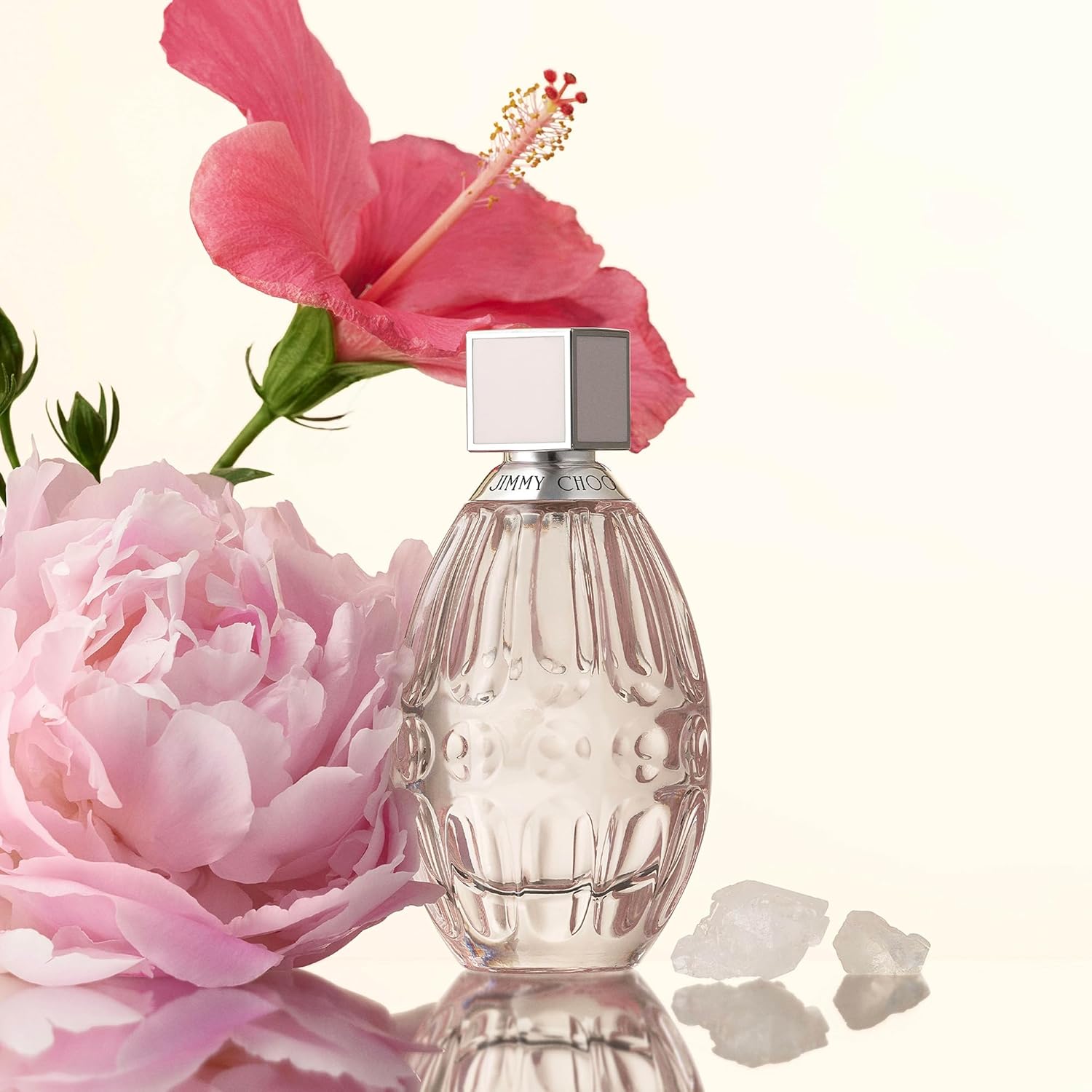 Elegant bottle of Jimmy Choo L'eau perfume by Elefair, featuring clear glass and silver accents on a white background.