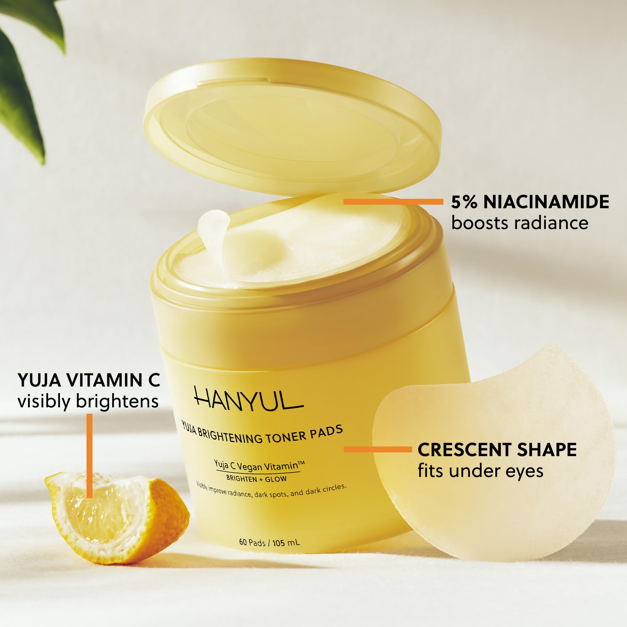Hanyul Yuja Toner Pads in a jar, featuring bright yellow citrus-infused skincare masks with textured surface for refreshing skin.