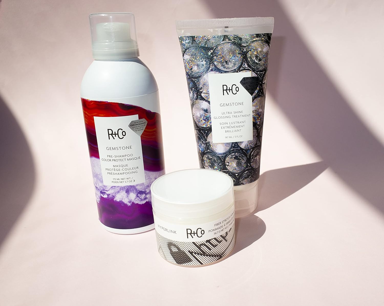 R+Co Gemstone Ultra Shine Glossing Treatment 147ml bottle with sleek packaging, designed to add shine and smoothness to hair.
