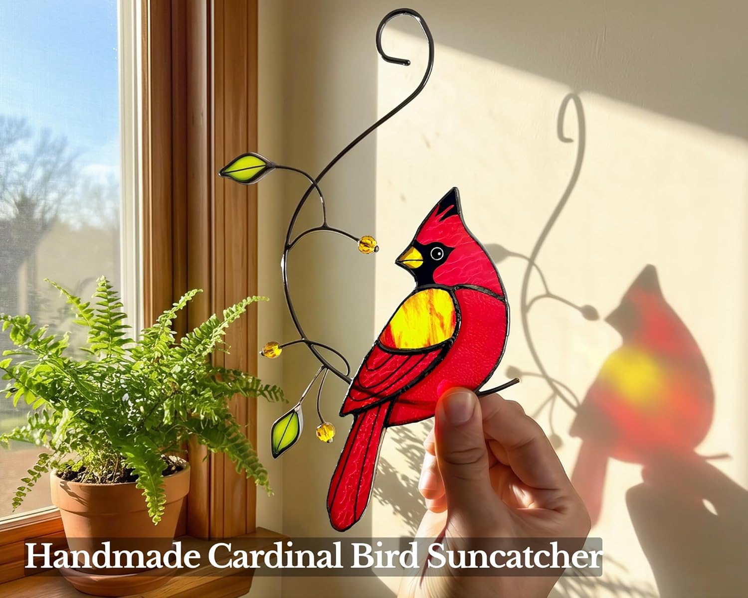Colorful cardinal stained glass sun catcher hanging on a window, handcrafted memorial gift by IriCrist featuring vibrant glass details.