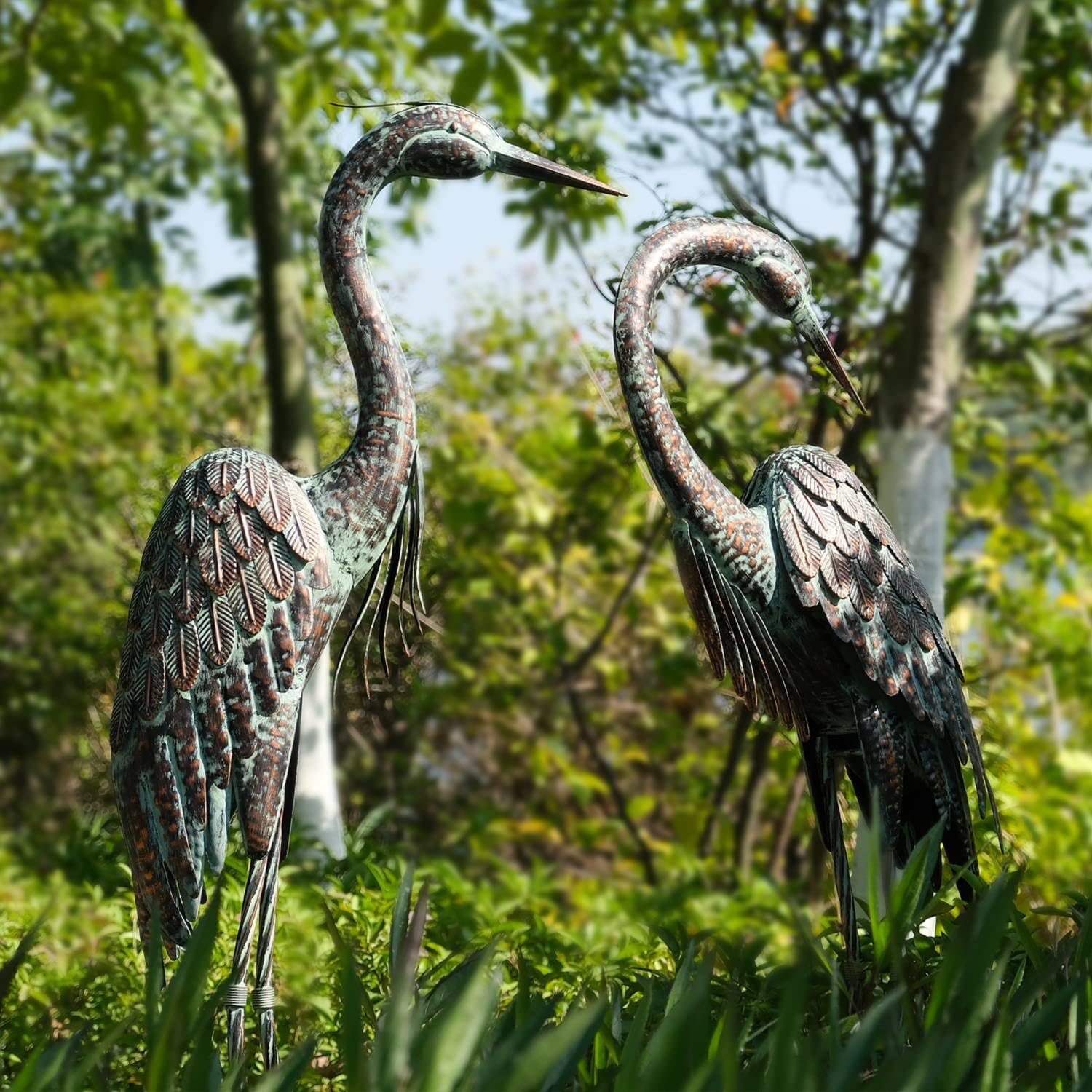 Kircust garden crane statue featuring a standing metal heron with a patina finish, designed as an outdoor decorative decoy.