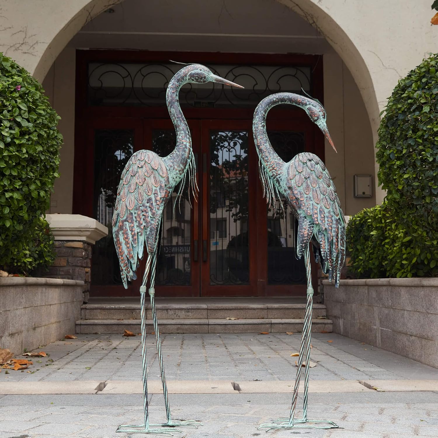 Kircust garden crane statue featuring a standing metal heron decoy with a patina finish for outdoor decoration.