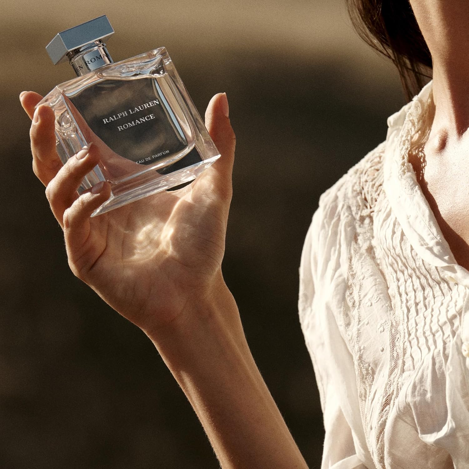 Ralph Lauren Fragrances Romance Eau de Parfum for women, elegant glass perfume bottle with floral accents.