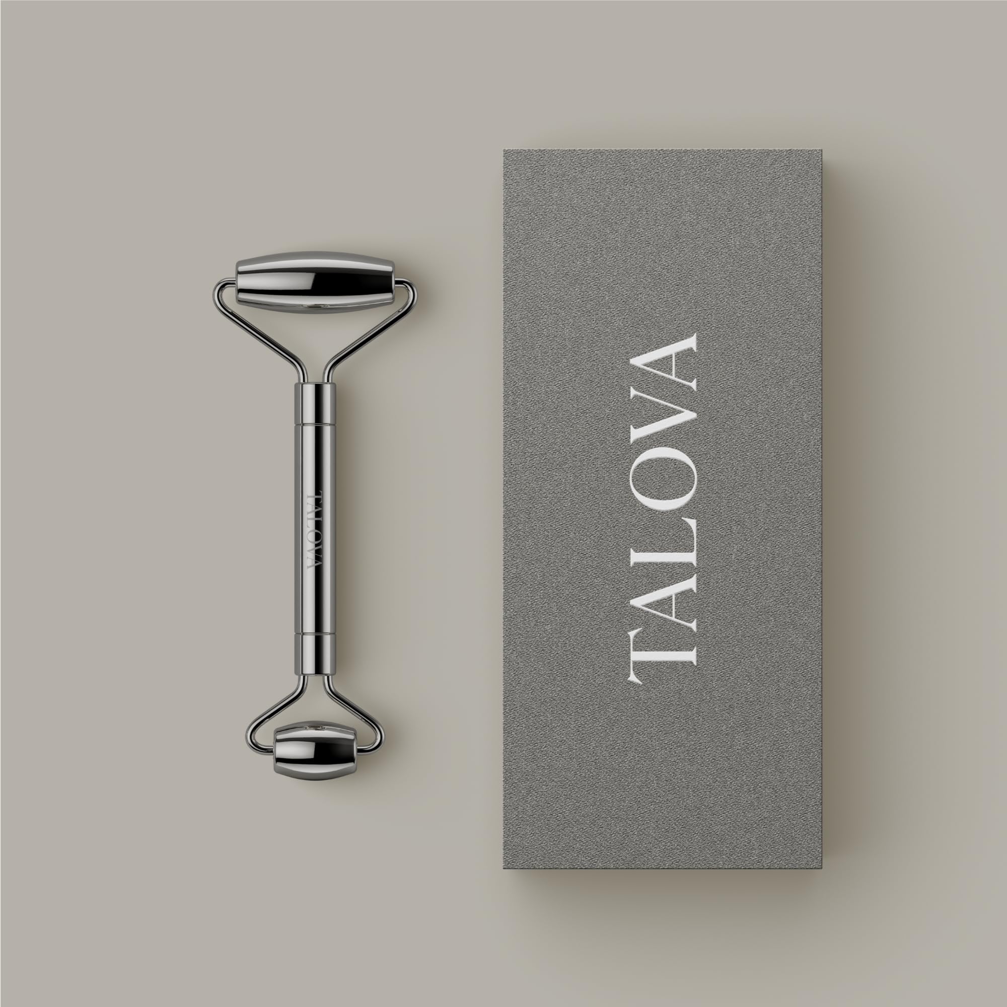 TALOVA stainless steel facial massage stick for depuffing and sculpting, shown in a close-up image with smooth, shiny surface.