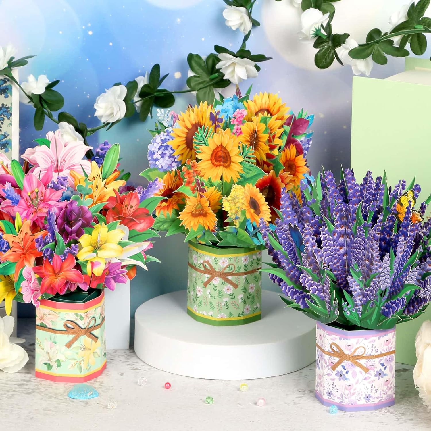 Three Caffox paper flower pop-up cards featuring 3D flower bouquet designs for greeting occasions, with vibrant floral details.