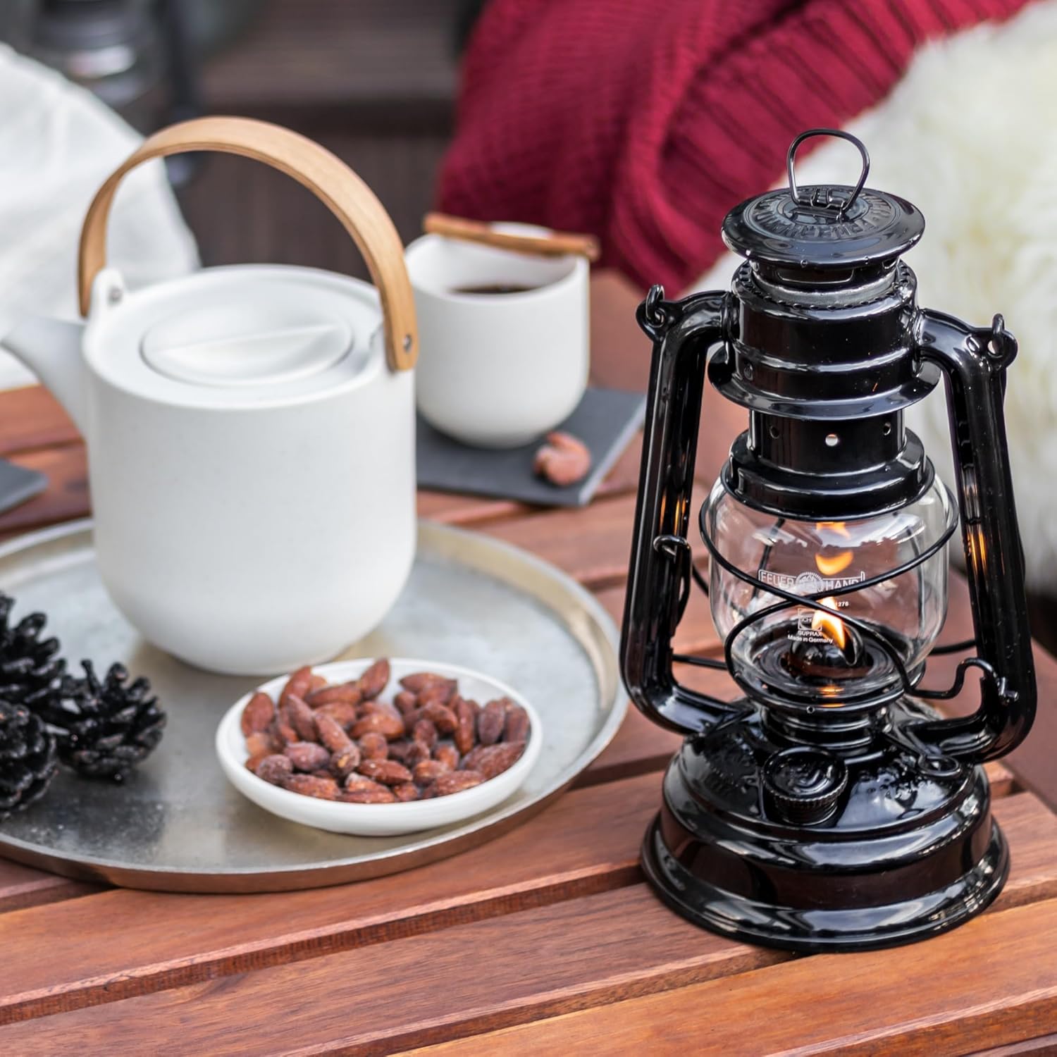 Feuerhand outdoor kerosene fuel lantern with weather-resistant design, German-made, featuring a metal handle and glass enclosure.