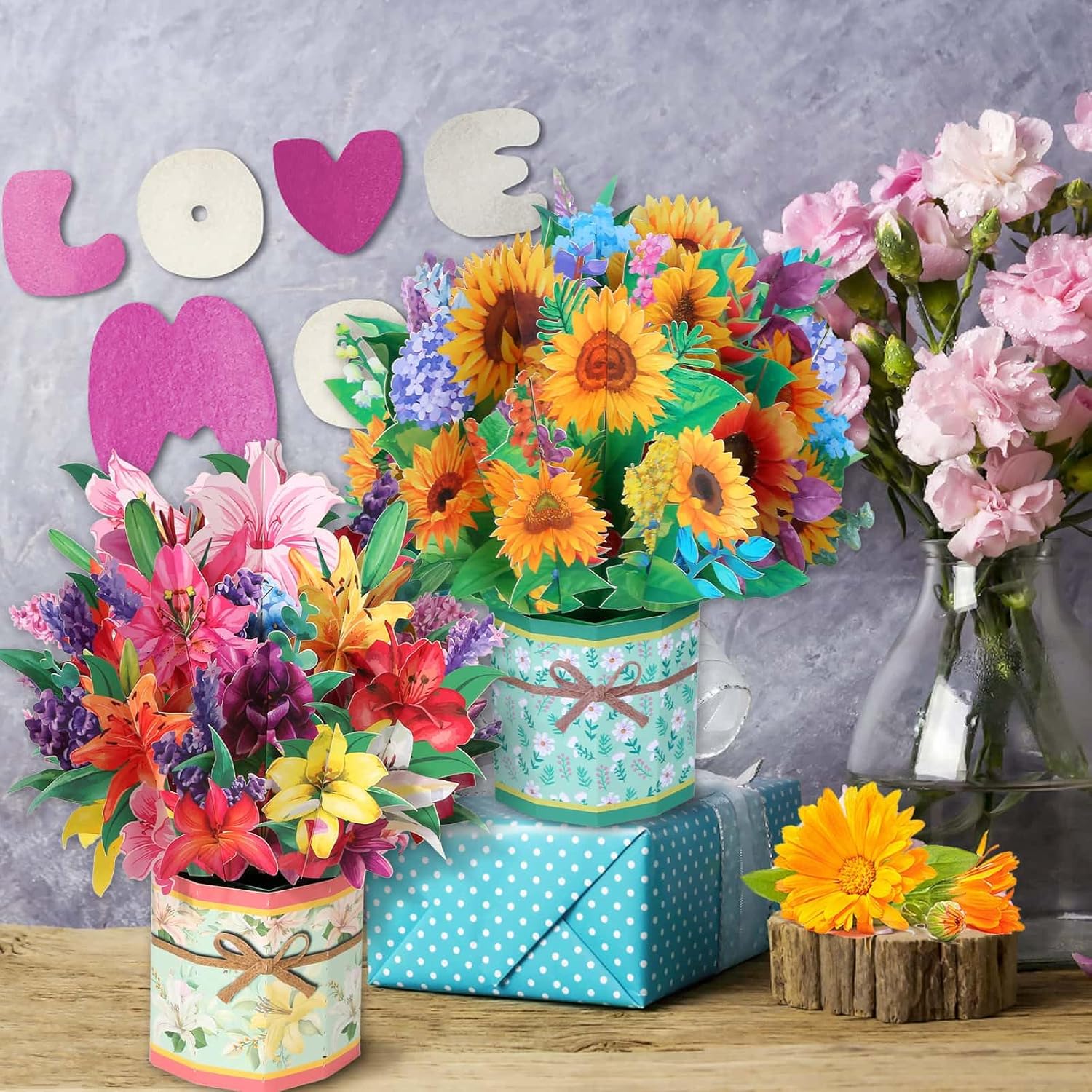 Three Caffox paper flower pop-up cards with 3D flower bouquet designs, showcasing vibrant, intricate floral greeting card artwork.