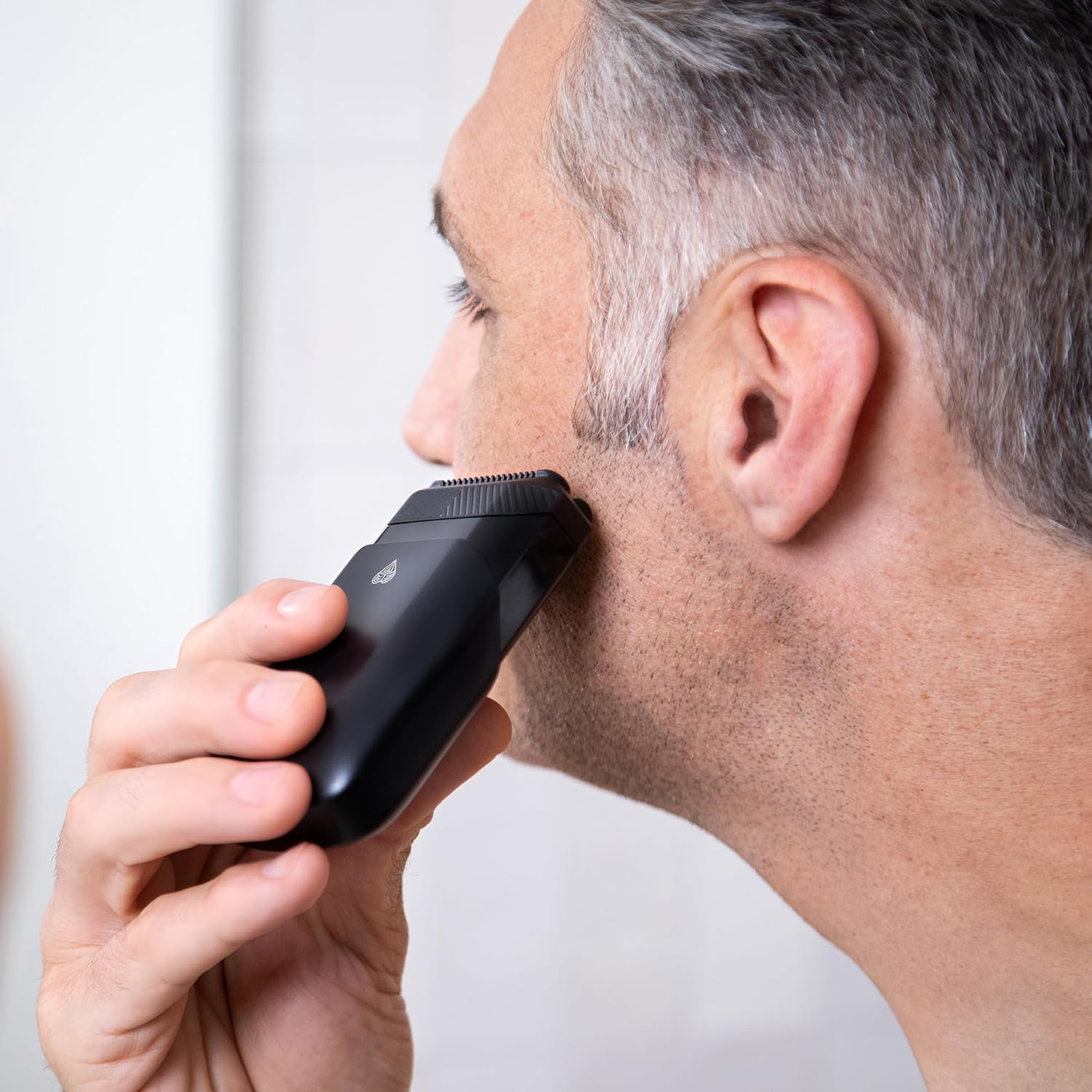 MANSCAPED The Handyman™ compact face shaver with a sleek design, ideal for men's travel grooming and facial hair trimming.