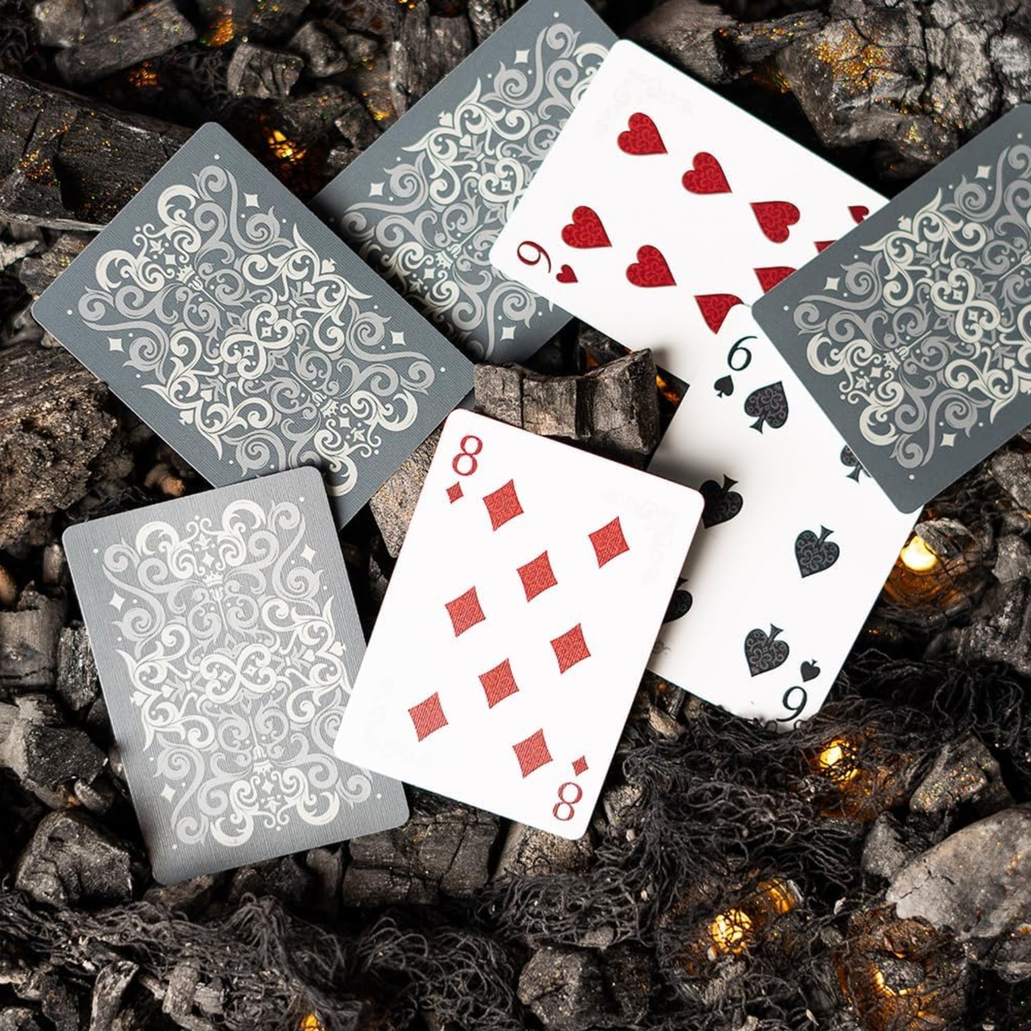 Bicycle Cinder Premium playing cards deck with silver smoke foil design, featuring standard face cards and card back illustration.