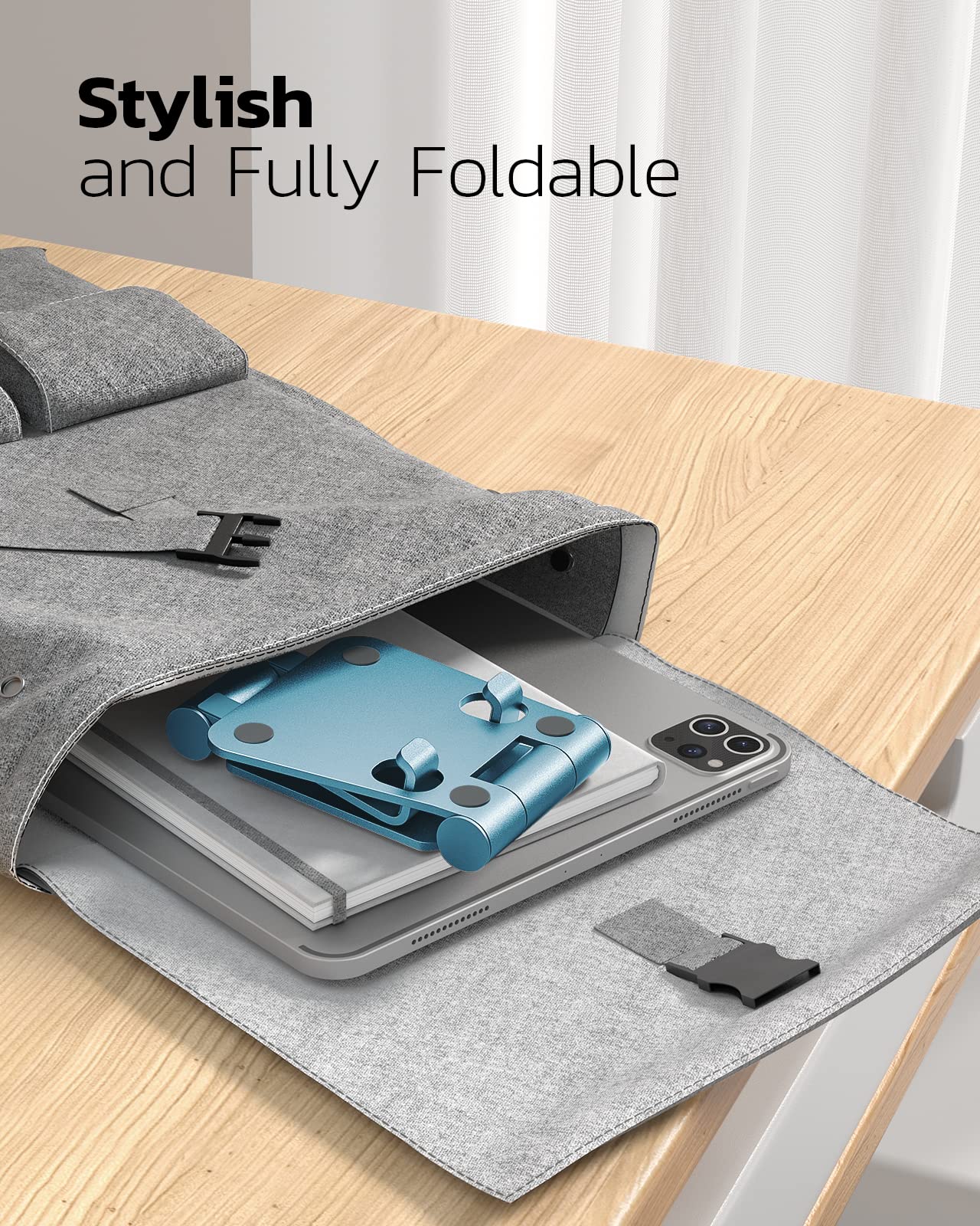 Nulaxy full aluminum dual folding cell phone stand in blue on a desk, portable electronic device holder for smartphones.
