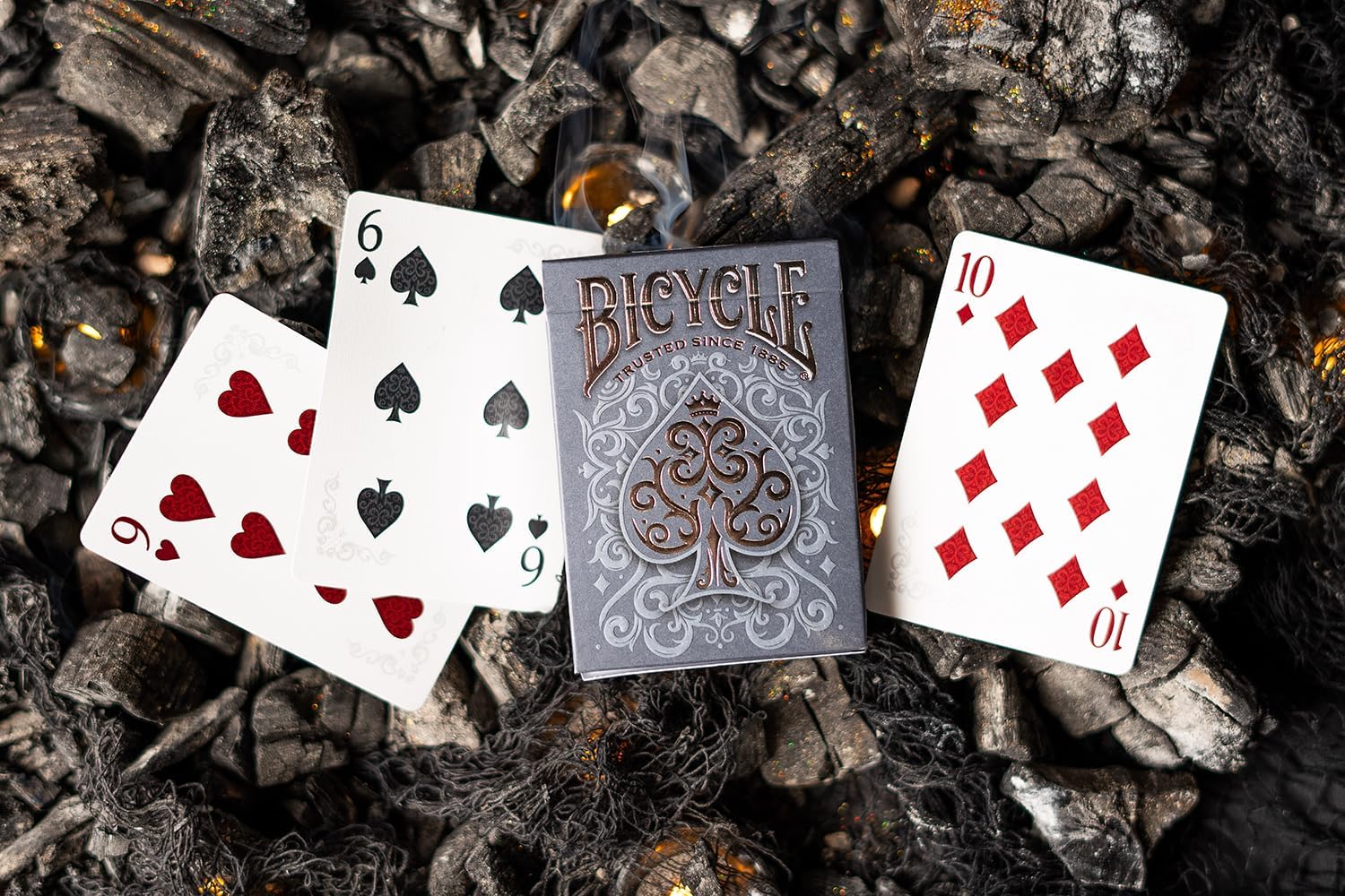 Bicycle Cinder Premium Playing Cards deck with silver smoke foil design, featuring detailed card faces and elegant packaging.