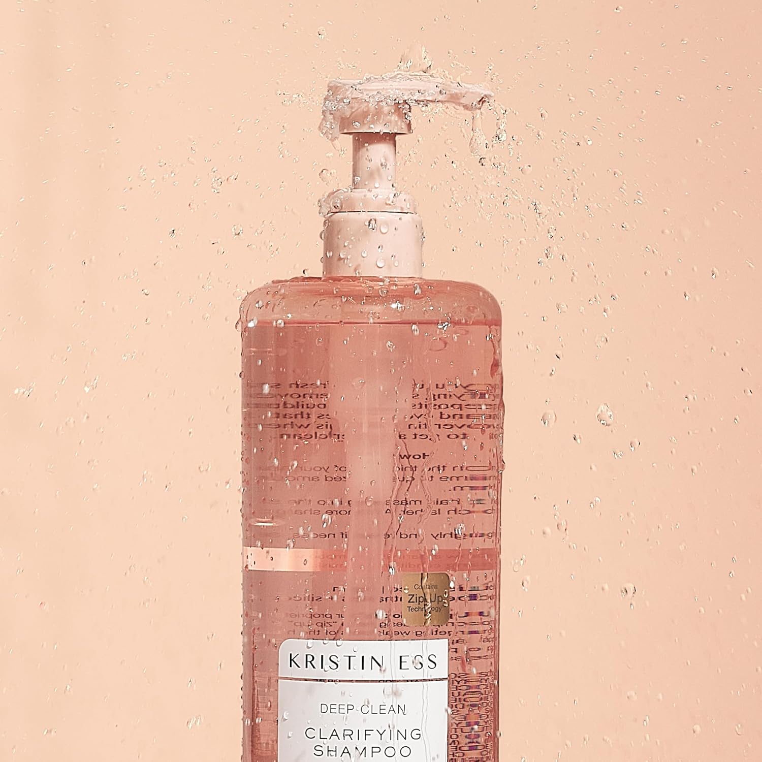 Kristin Ess clarifying shampoo in a clear bottle with pump dispenser, designed for deep cleansing and scalp refreshment.