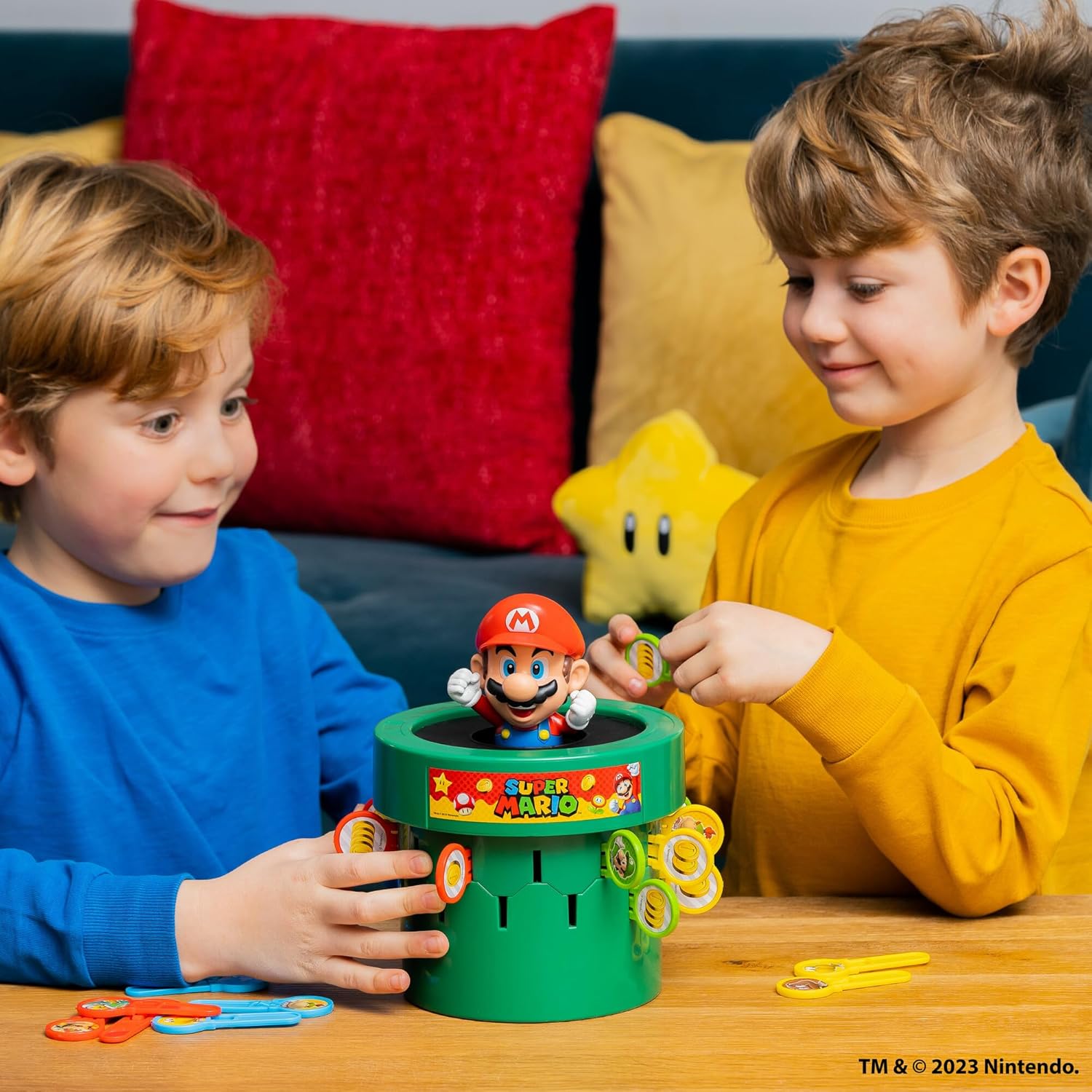 TOMY Pop Up Super Mario game with colorful game pieces and game board, ideal for indoor recess and family game nights