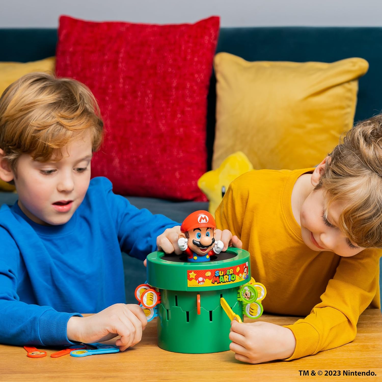 TOMY Pop Up Super Mario game with colorful game pieces and cards for indoor recess or family game night entertainment.