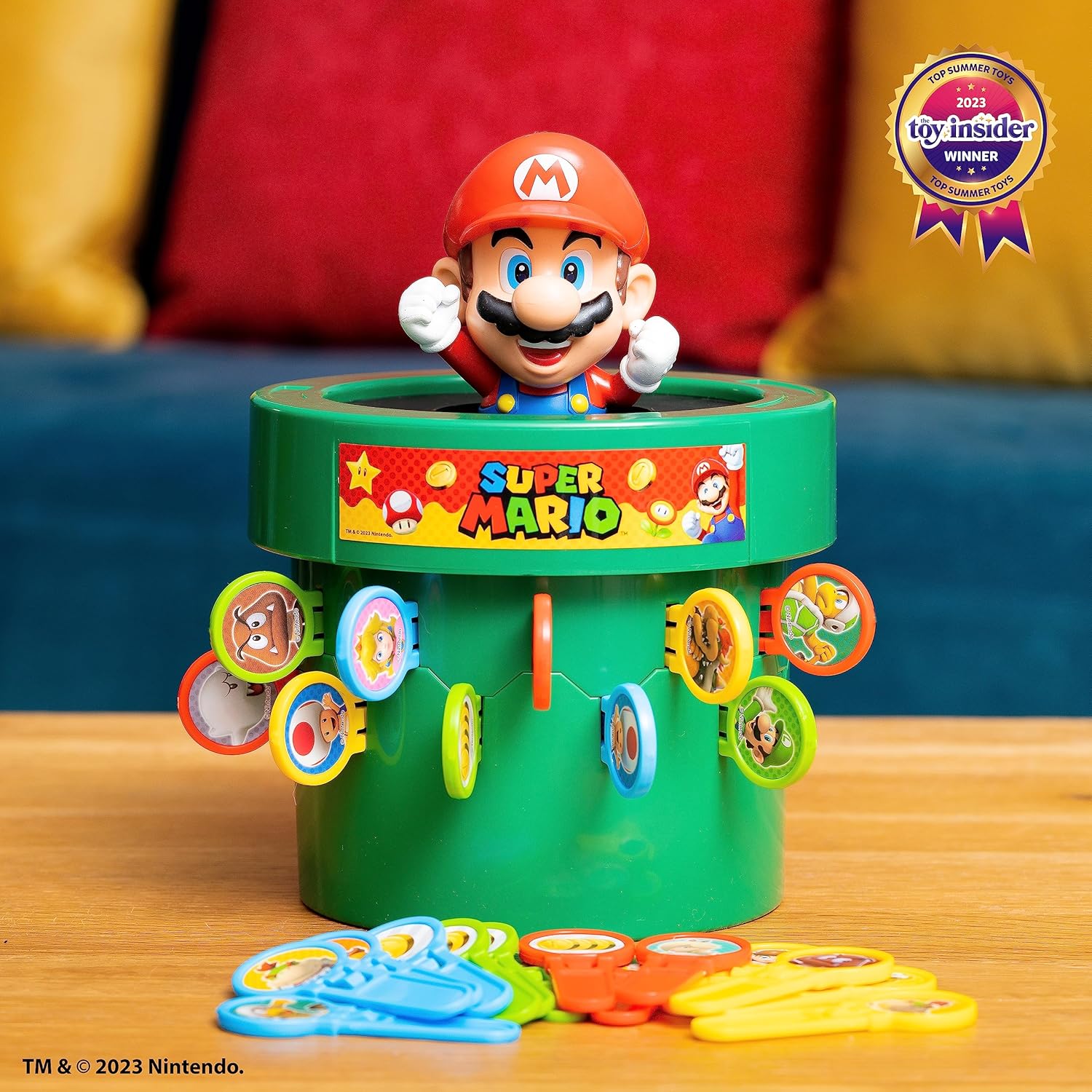 TOMY Pop Up Super Mario game featuring colorful game pieces and a game board for indoor recess or family game night.