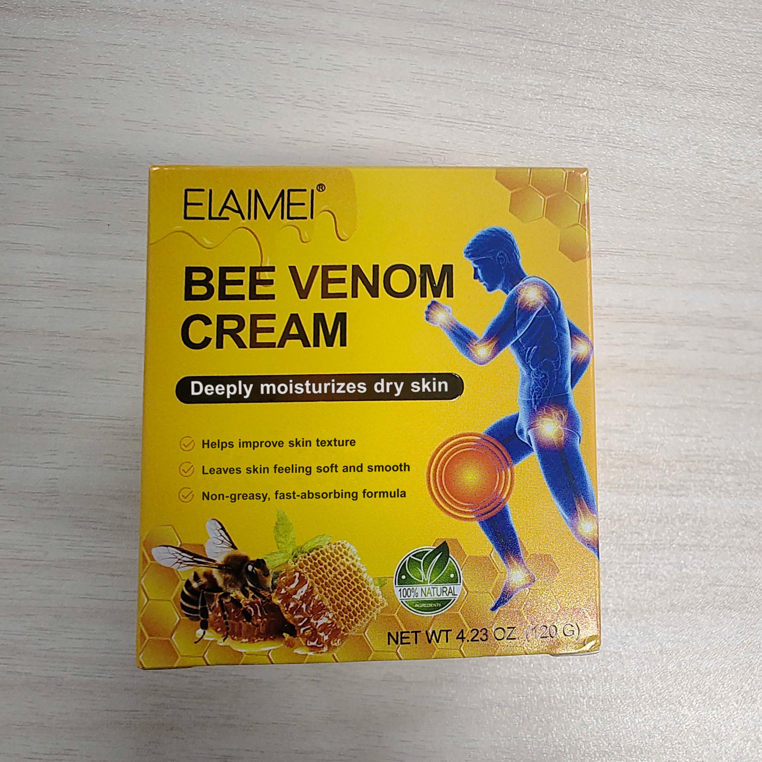 IKZEE Bee Venom Cream, a natural face and body moisturizer, shown in a jar with honeycomb and beeswax for skincare.