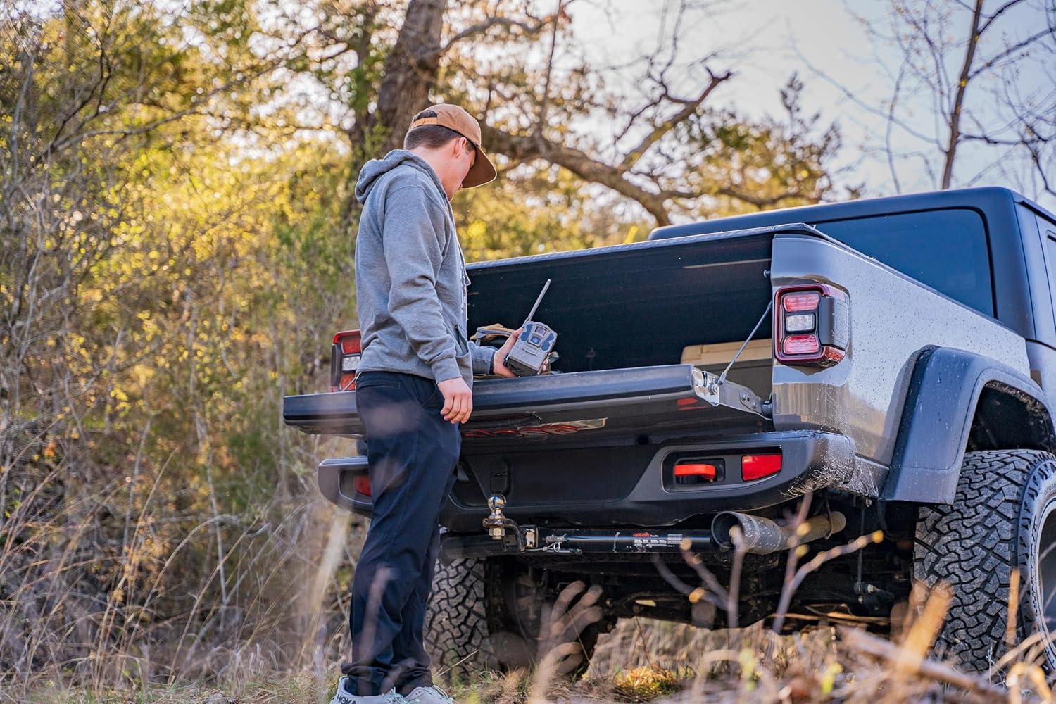 Tactacam REVEAL X Gen 3.0 cellular trail camera displaying HD photos and videos in a natural outdoor setting.
