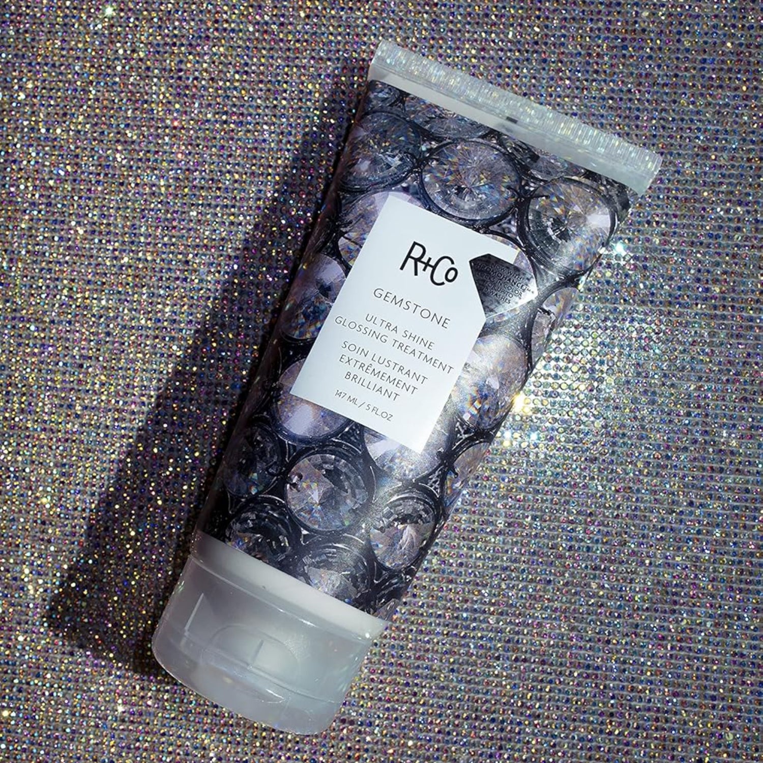 R+Co Gemstone Ultra Shine Glossing Treatment in 147 ml bottle, showing the sleek packaging and product label.
