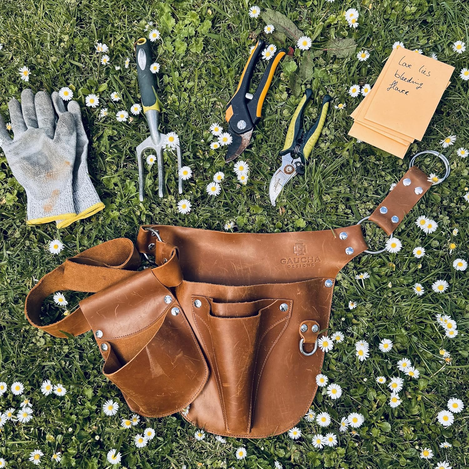 Gaucha Designs leather garden tool belt with multiple pouches for gardening tools, ideal for women and garden enthusiasts.