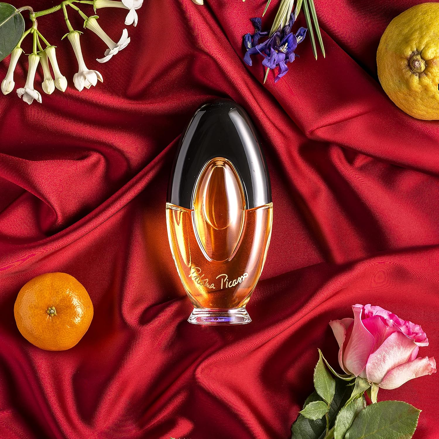 Elegant bottle of Paloma Picasso Eau de Parfum for women featuring notes of bergamot, rose, and amber.