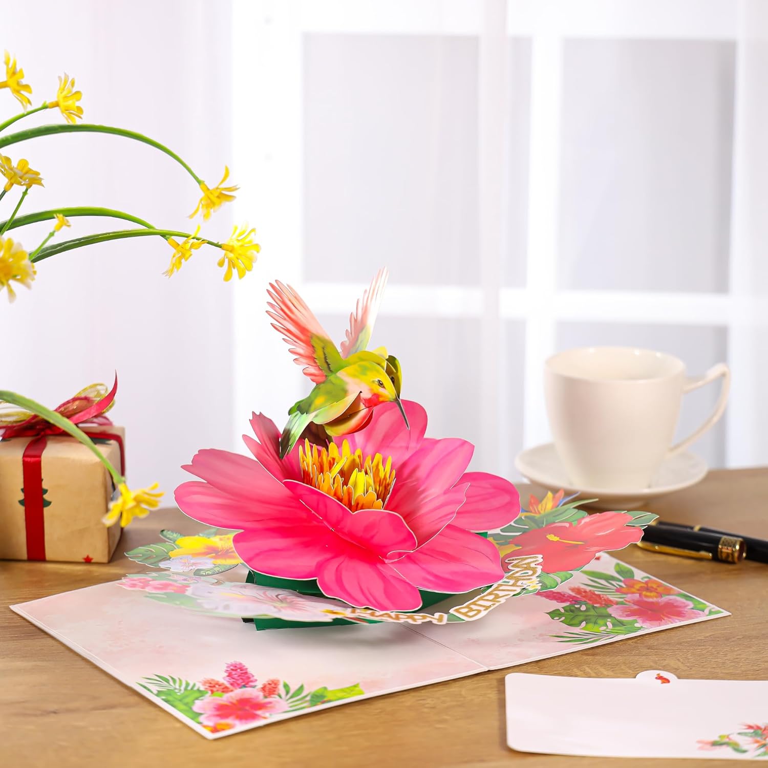 SISTIMON hummingbird pop-up birthday card for women featuring a colorful hummingbird perched on vibrant flowers.