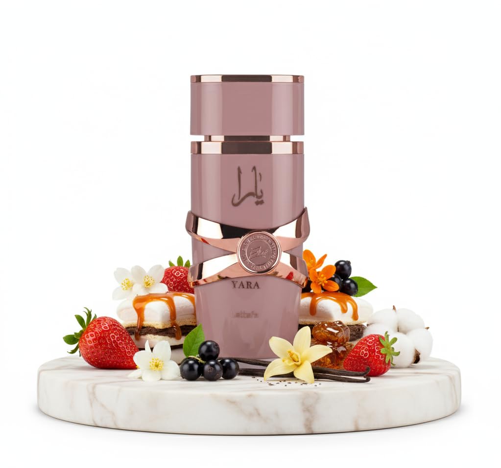 Pink and rose gold perfume bottle on a marble platform with fruits and flowers