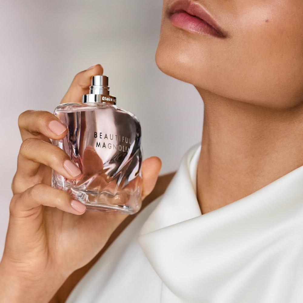 Estée Lauder Beautiful Magnolia Eau de Parfum spray bottle with lush magnolia flowers and elegant packaging.