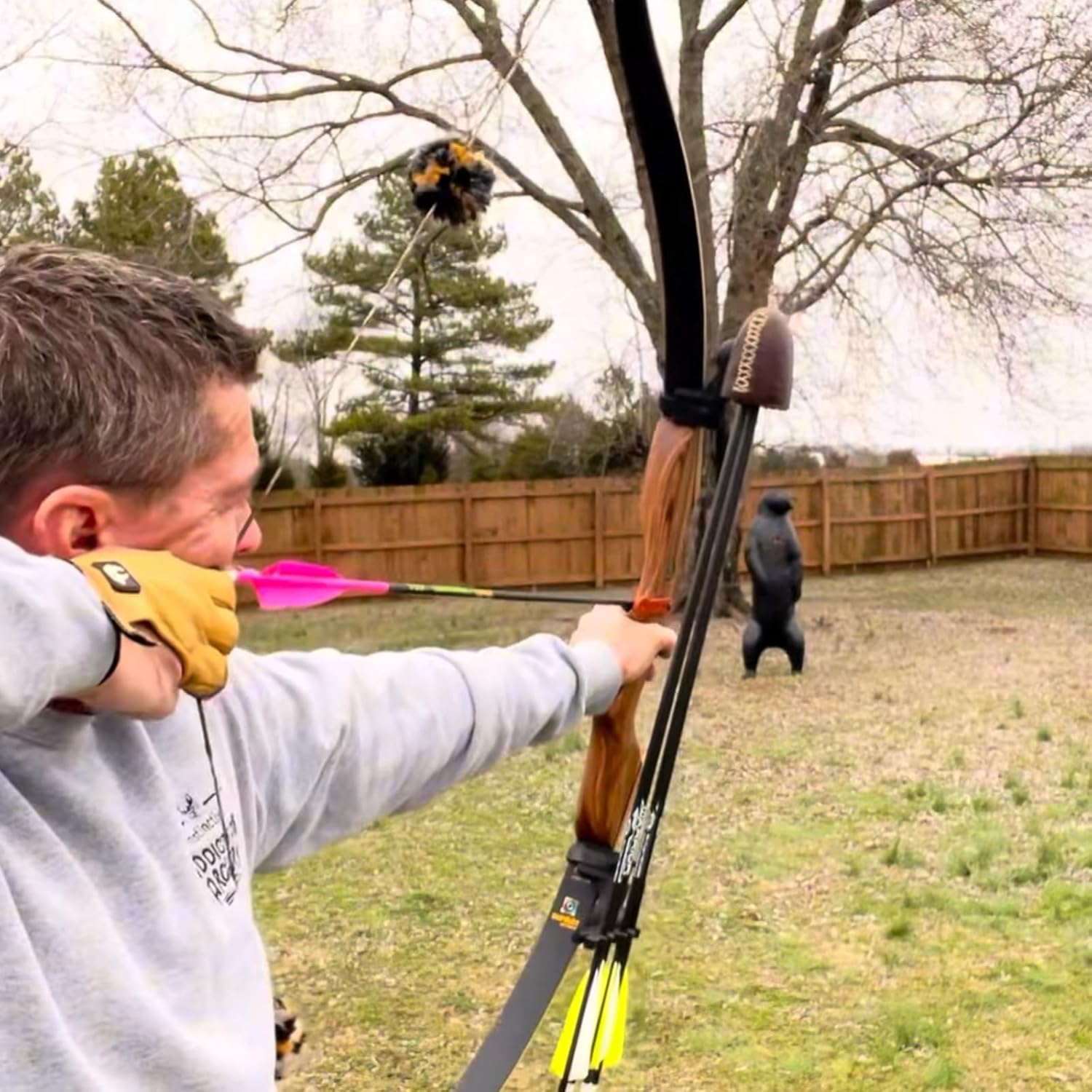 Sanlida Eagle X9 58-inch recurve bow with matching arrows, wood grip, and bow string, ready for archery practice.