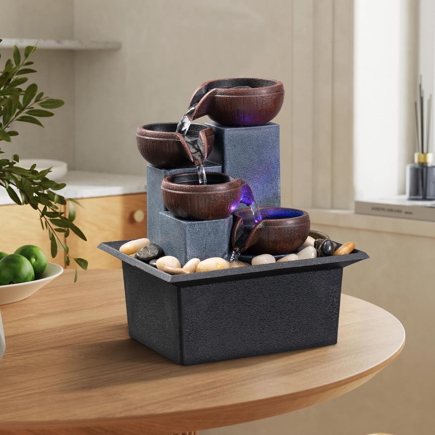 Small indoor AMOOTEK tabletop fountain with four-tier waterfall, relaxing water feature for home decor.