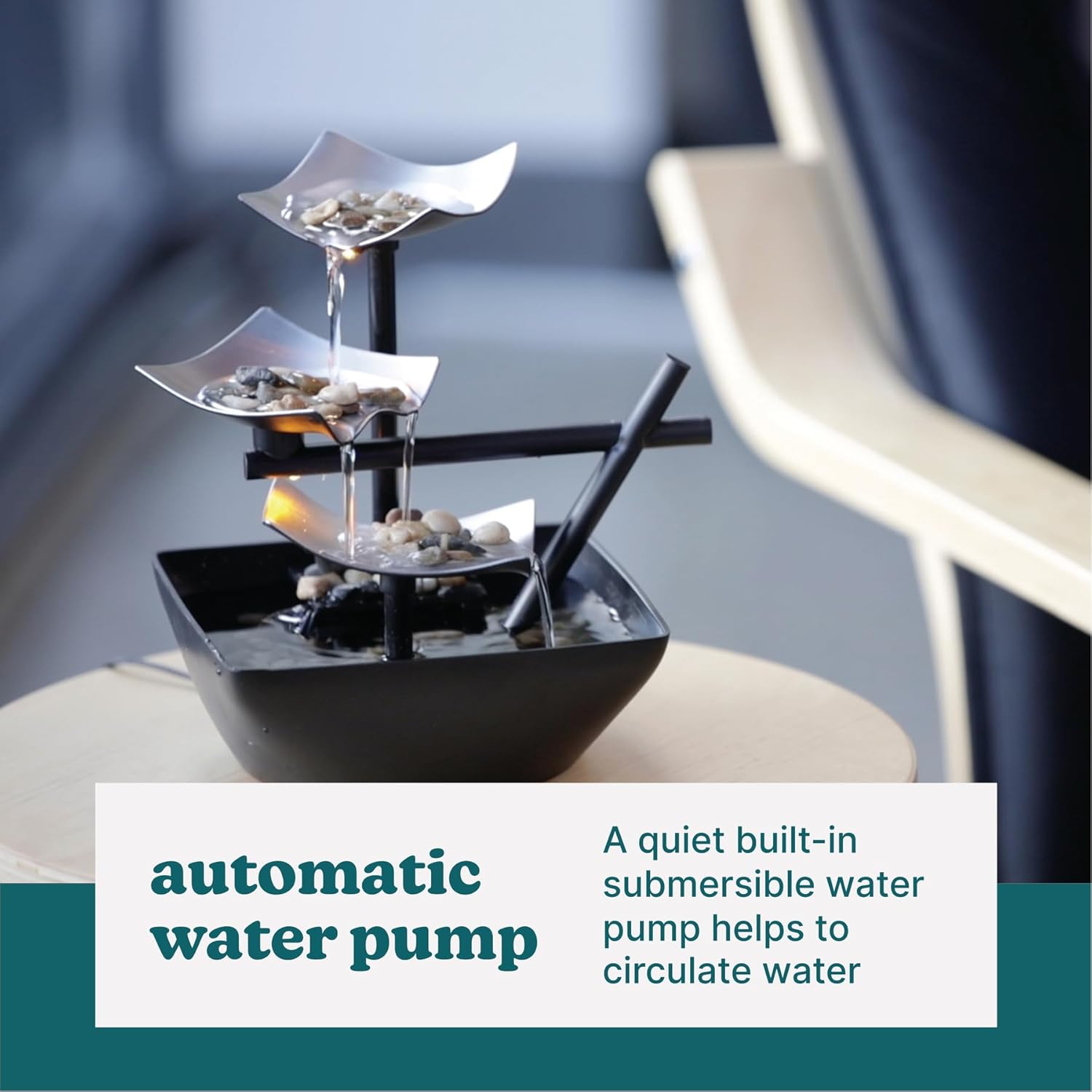 Decorative water fountain with automatic water pump on a blurred background